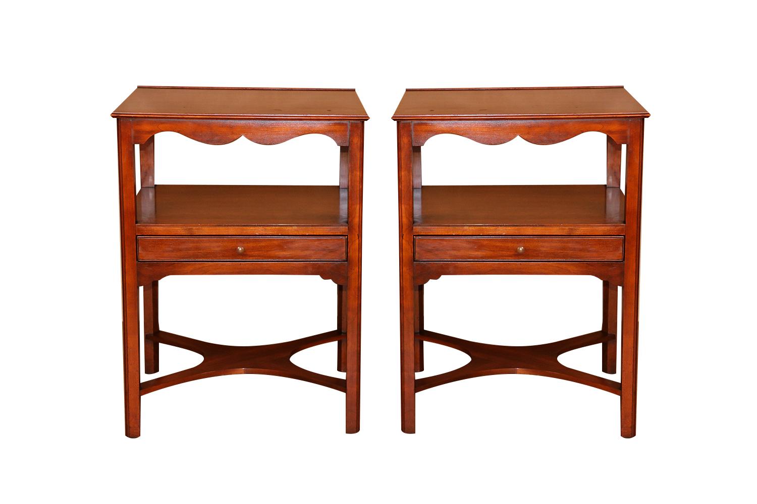 An exceedingly fine pair of matching, solid wild black cherry two tier nightstands/ side tables by Henkel Harris, Virginia Galleries collection, crafted of solid wild black cherry, beautiful form. Each features a square top with shaped apron above a