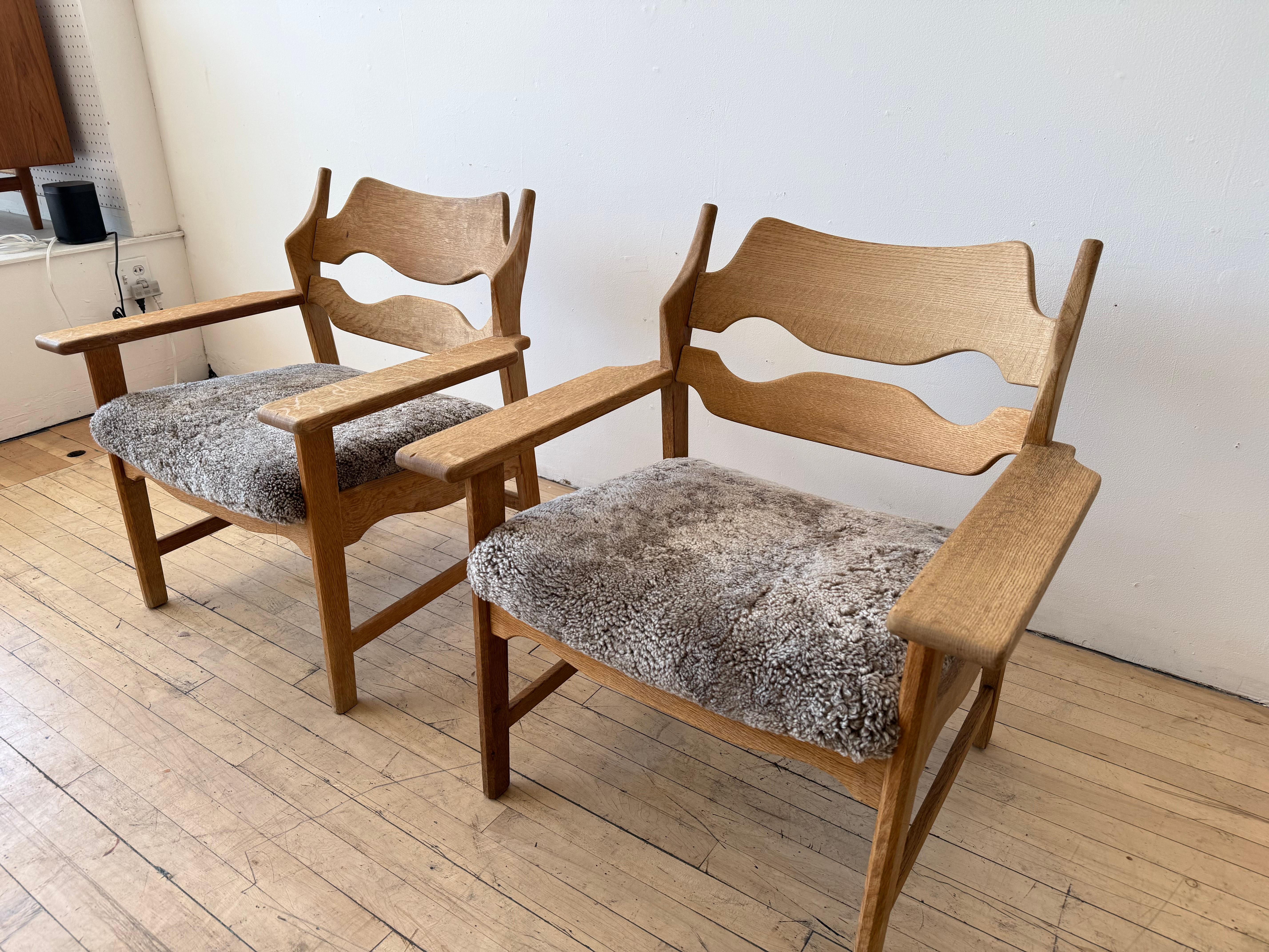 Sheepskin Pair Henning Kjaernulf lounge chairs For Sale
