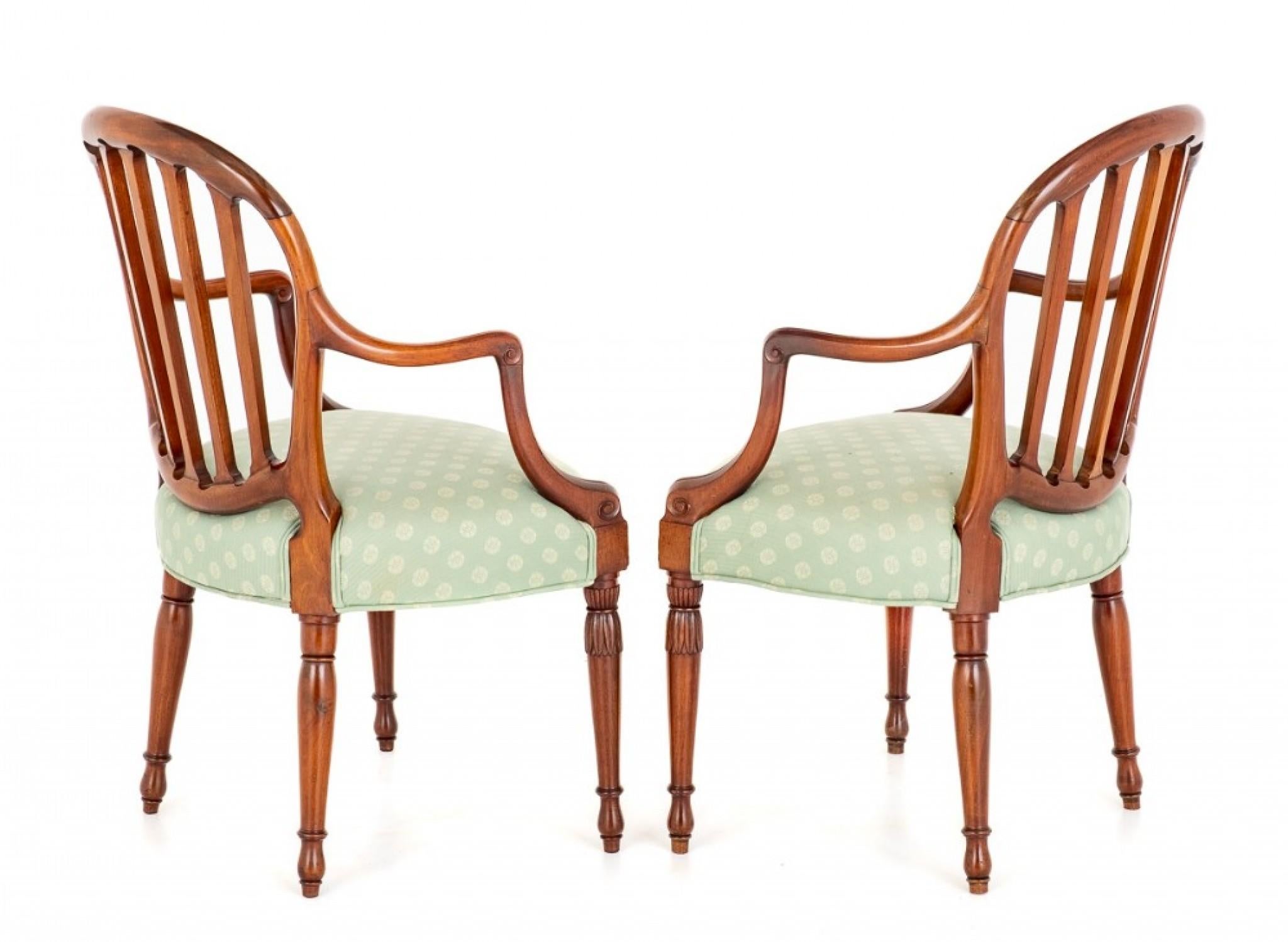A good quality pair of mahogany hepplewhite revival open arm chairs.
The front legs being of a turned and carved form.
circa 1900
The arm supports being of a shaped form.
The shaped backs of the chairs having five uprights with floral