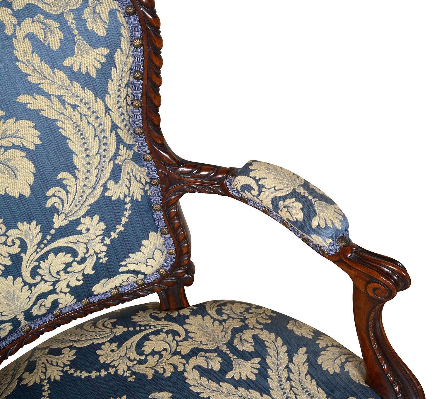 A pair of good quality Georgian Hepplewhite style Mahogany arm chairs, each with upholstered backrest, seat and arm rests, carved gadrooned pattern decoration, raised on elegant cabriole legs, terminated in scrolling feet.

Batch 76. Dean G100030/23