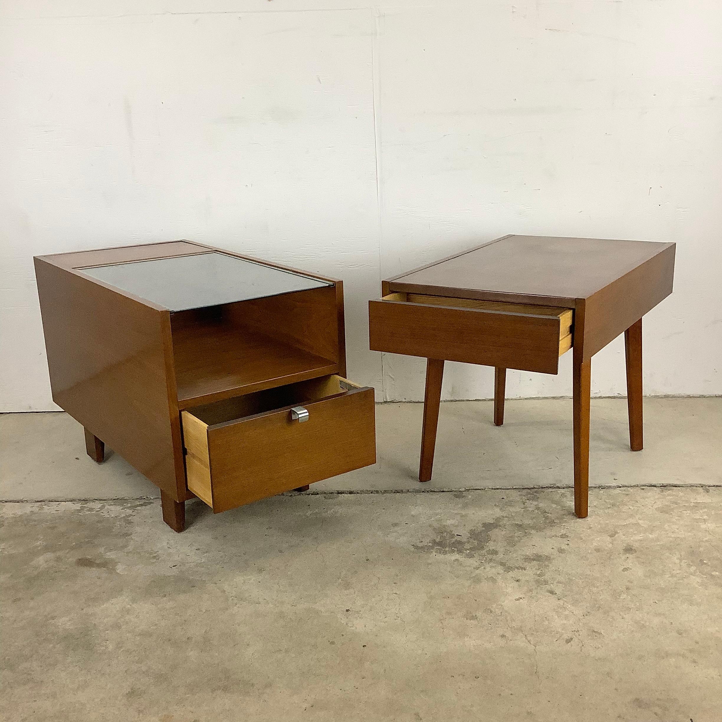 This stunning pair of midcentury side tables by George Nelson for Herman Miller make a striking vintage addition to home or business seating areas. One with glass top and storage double sided with shelves and drawer for storage, the other with