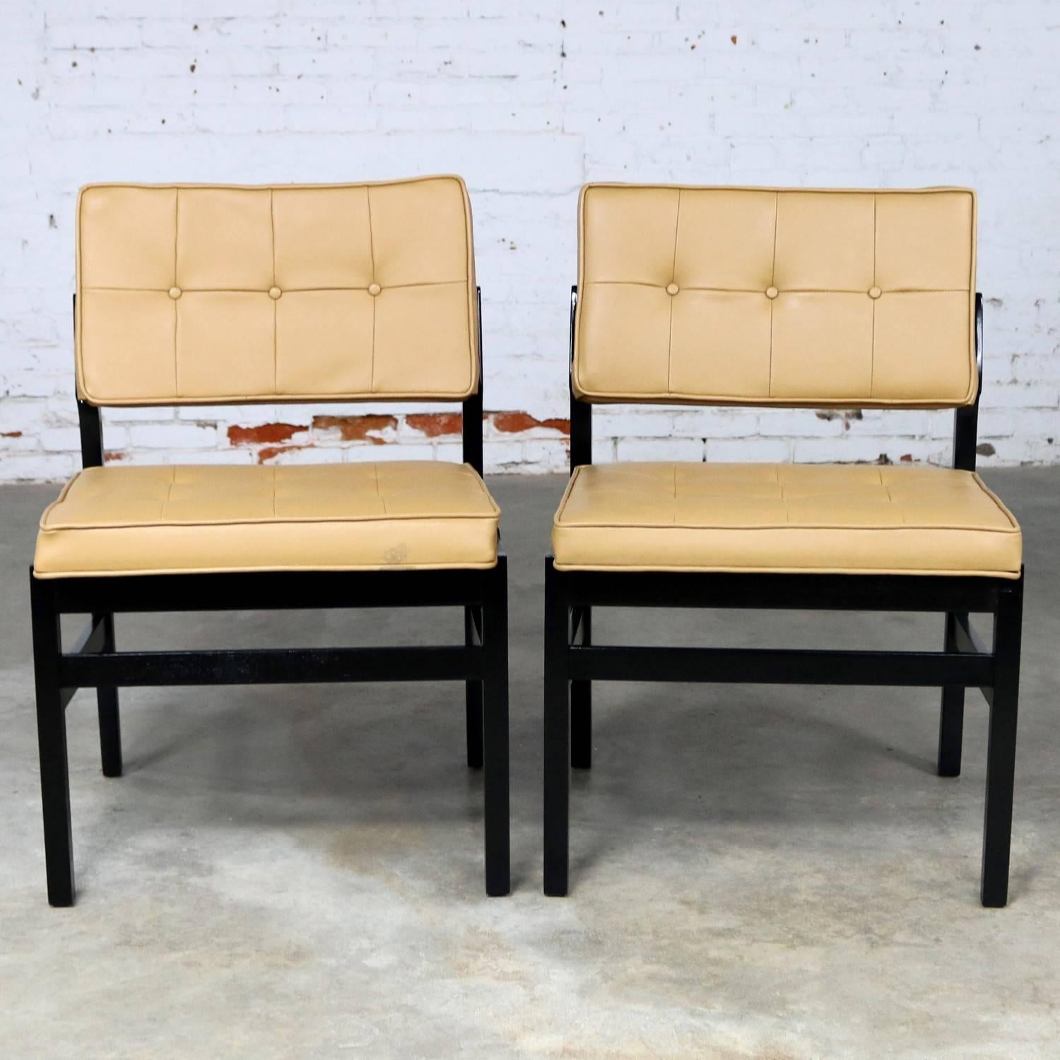 Handsome pair of Hibriten Chair Co. side chairs. Their great geometric wooden frames have been blackened with dye and they retain their original greenish gold faux leather upholstery and Hibriten tag. They are in wonderful vintage condition;