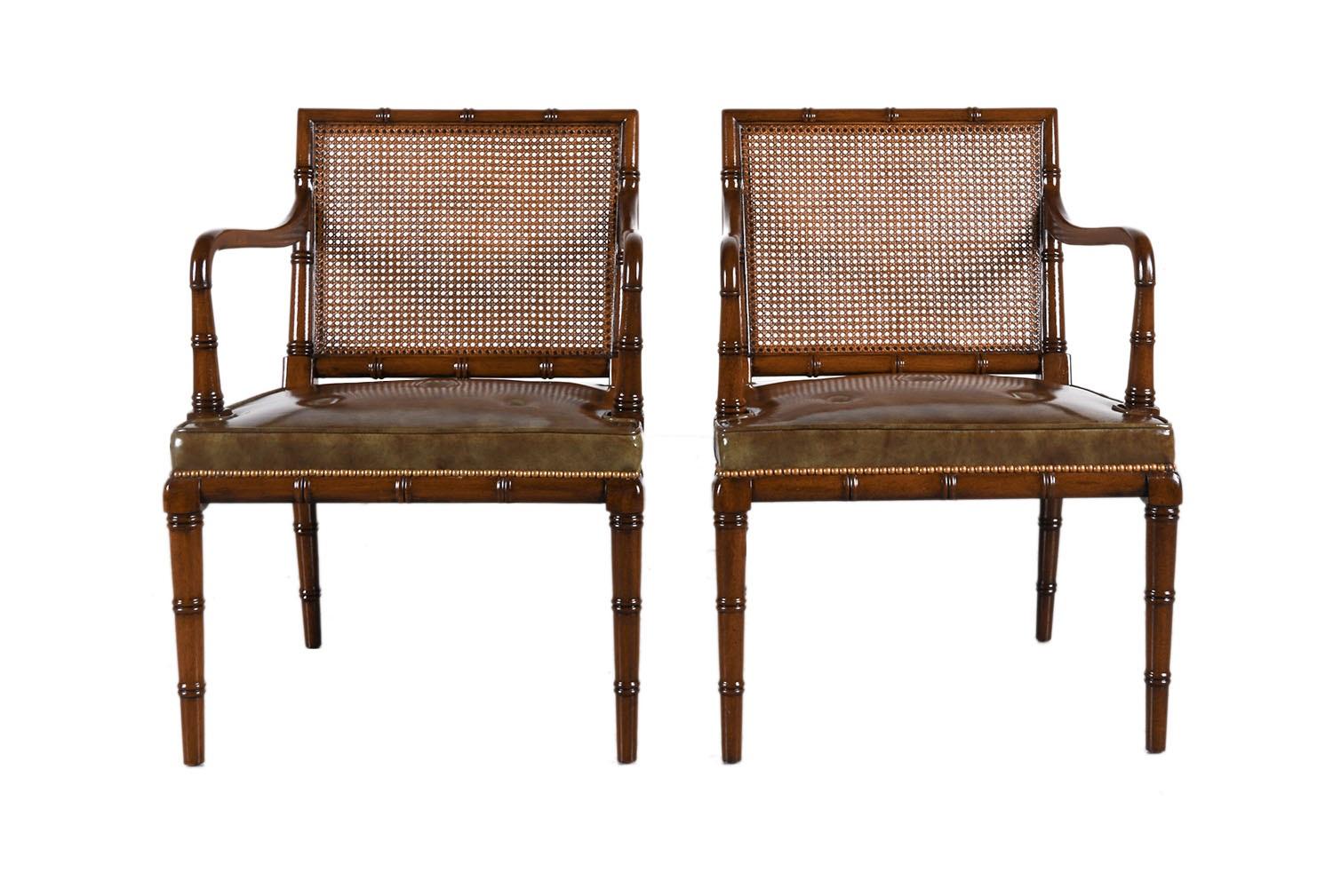 A beautiful rare pair of Hollywood Regency-style accent chairs by Hickory Chair N.C. This rare pair features faux bamboo frames with caned backs which make an interesting focal point for the eye while the gentle subtle outward-splay back legs
