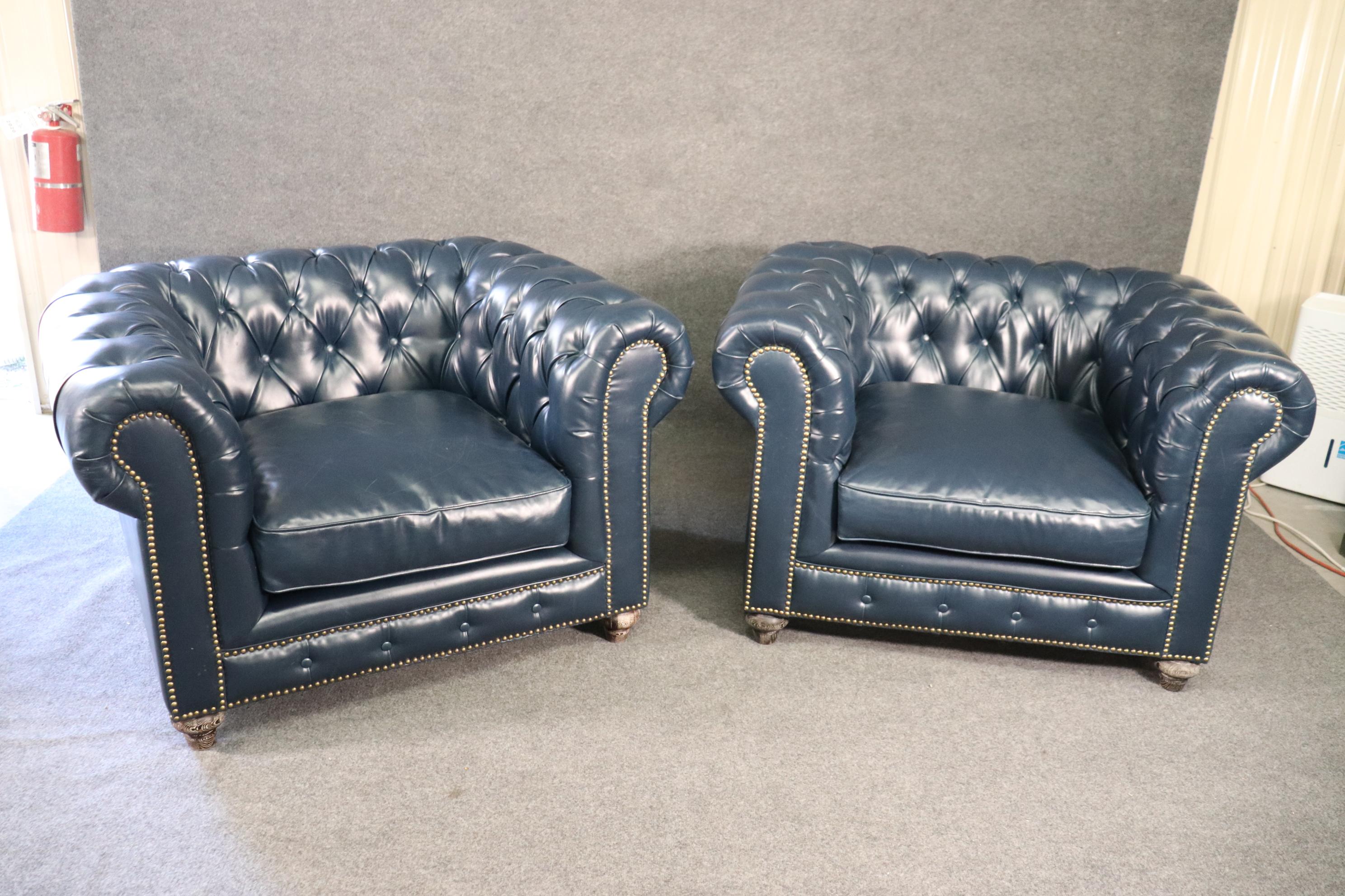 This is a superb quality pair of Chesterfield chairs in navy blue top grain leather. The chairs are in good original used condition and will show some minor signs of age and use but are stunning and massive. They have scale and will dominate a room.