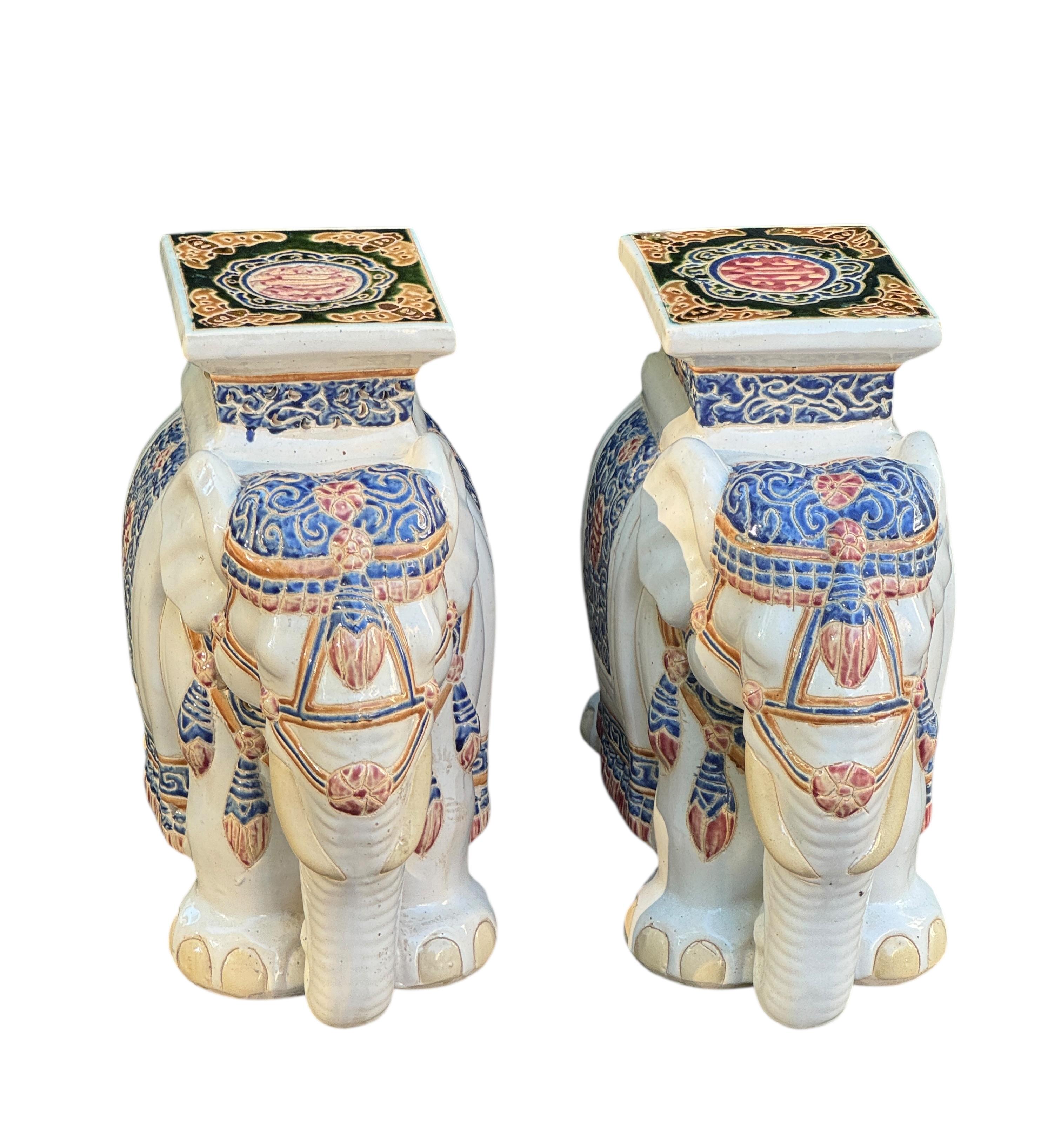 Pair of Mid-20th century glazed ceramic elephant garden stool, flower pot seat or side table. Handmade of ceramic. Nice addition to your home, patio or garden. A nice addition to any room, patio or yard. Also nice at the pool as a drinks stand.
  