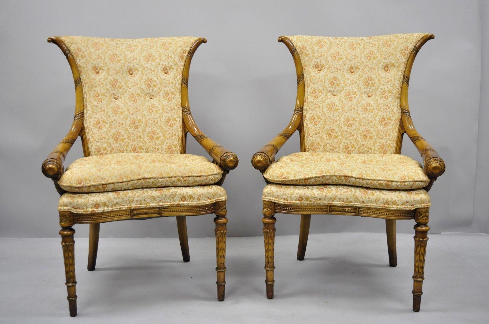 Pair of Hollywood Regency French style Cornucopia carved chairs after Grosfeld House. Item features solid wood construction, distressed finish, nicely carved details, tapered legs, and sleek sculptural form, circa early to mid-20th century.