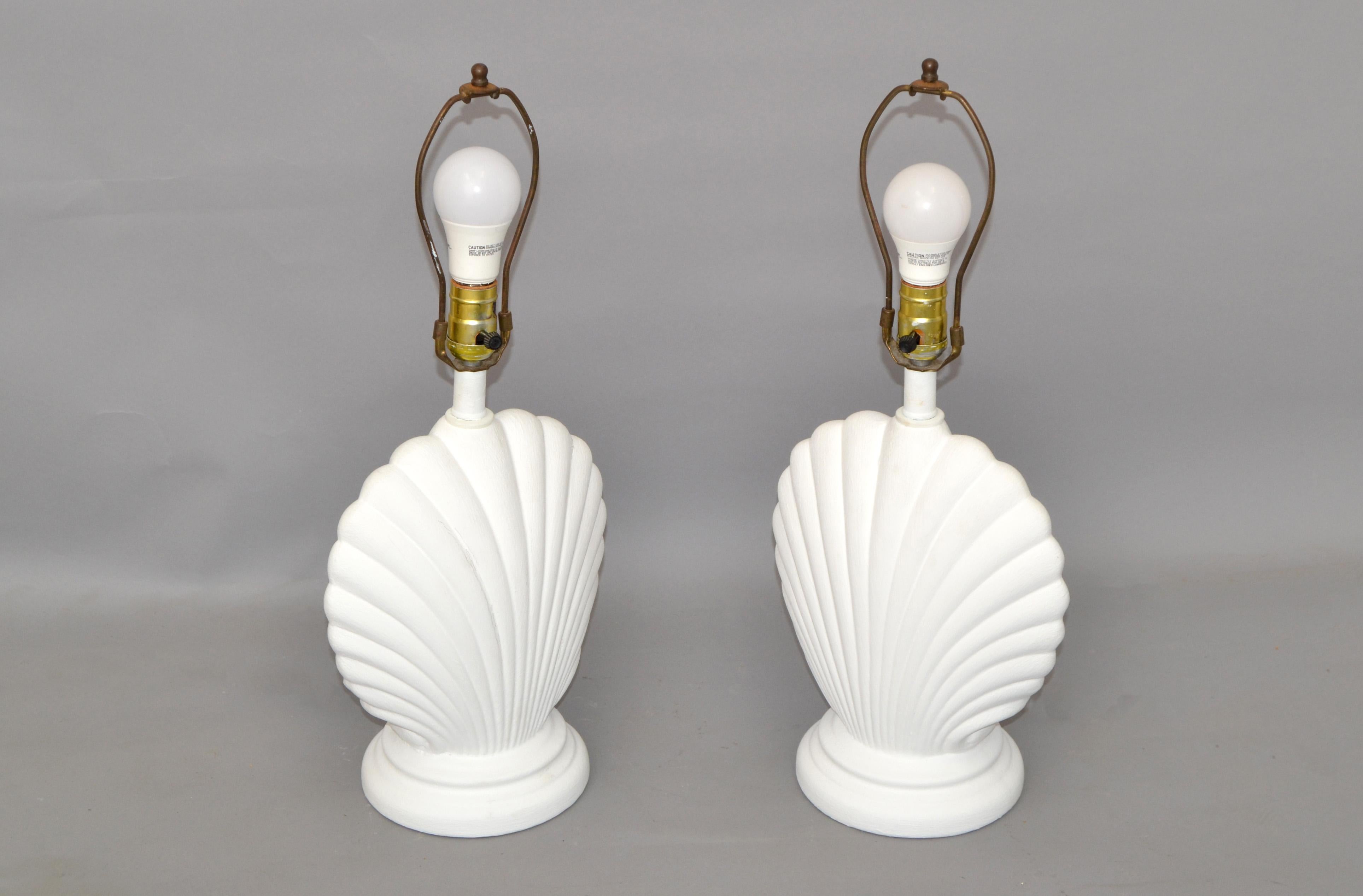 We offer a Pair of Hollywood Regency nautical seashell shaped Plaster Table Lamps with Harp and Finial.
Recently refinished in off white Gesso.
US Wiring and each Lamp takes a regular or LED light bulb.
No Shades.