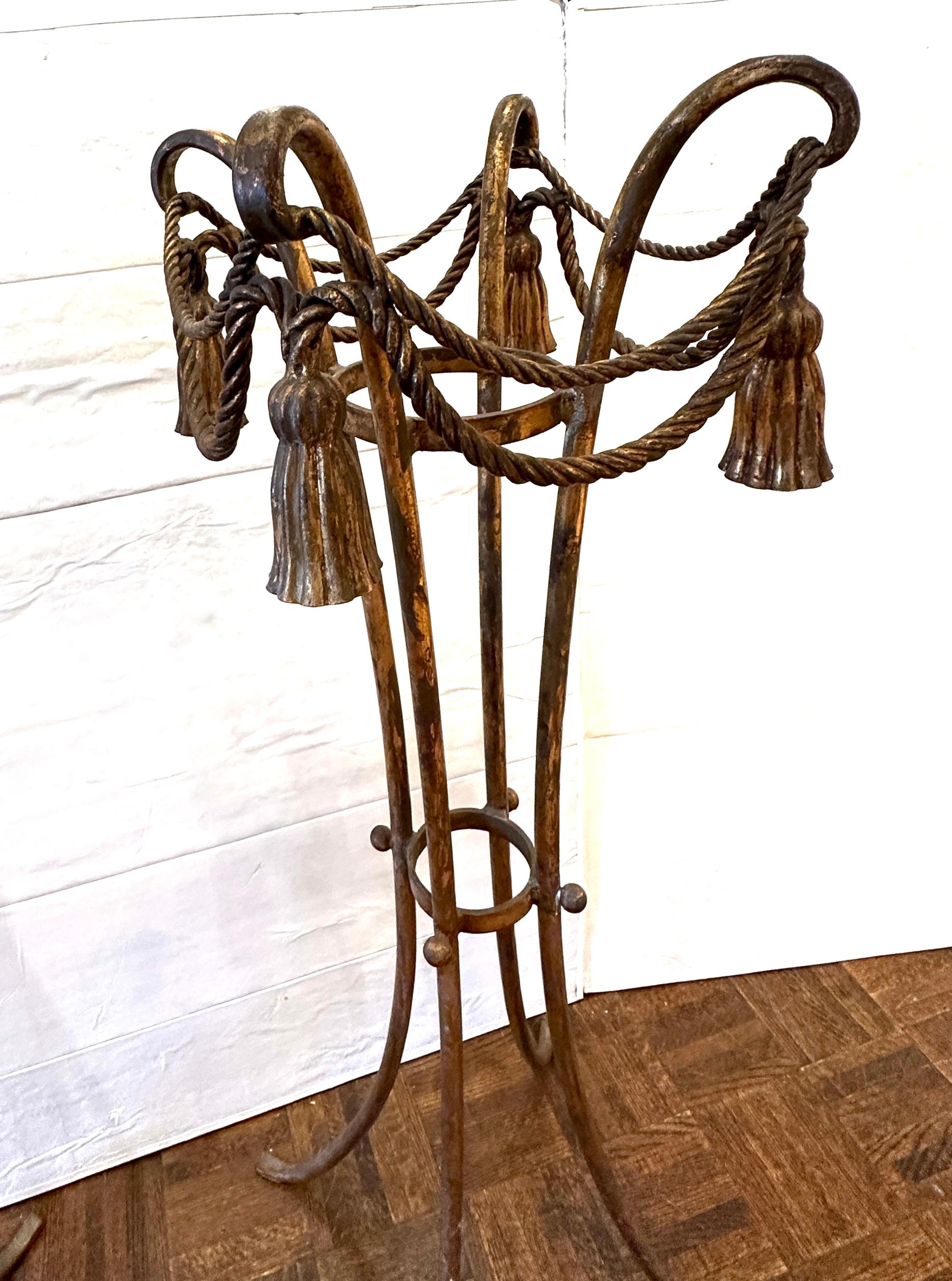 Pair, Hollywood Regency plant stands.  In wrought iron, gilt gold, festooned with tassels.  