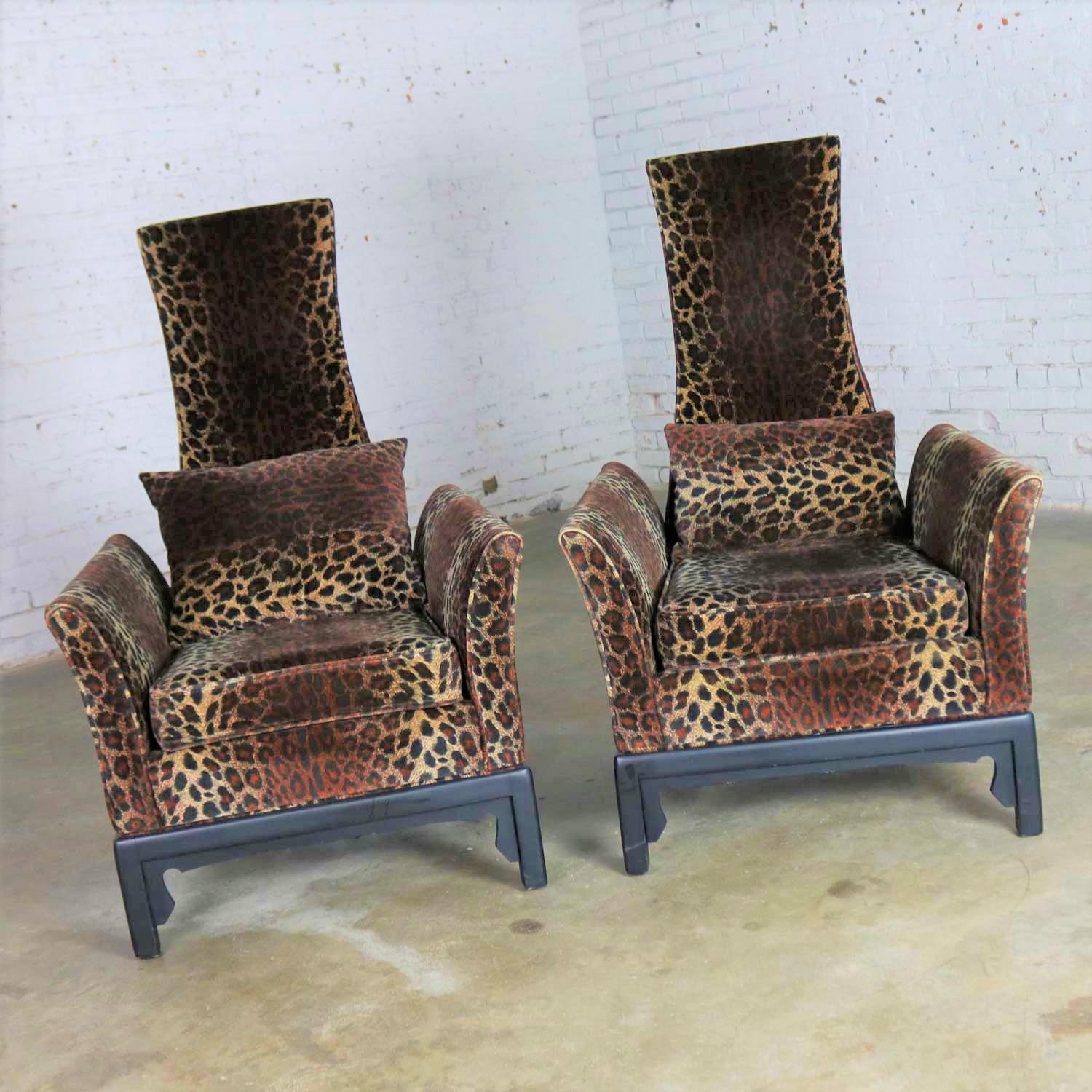 Outstanding pair of midcentury Hollywood Regency lounge chairs with high narrow backs made in the style of the infamous James Mont and upholstered in gorgeous animal print velvet on an Asian Style black wood base. They are in fabulous condition. The