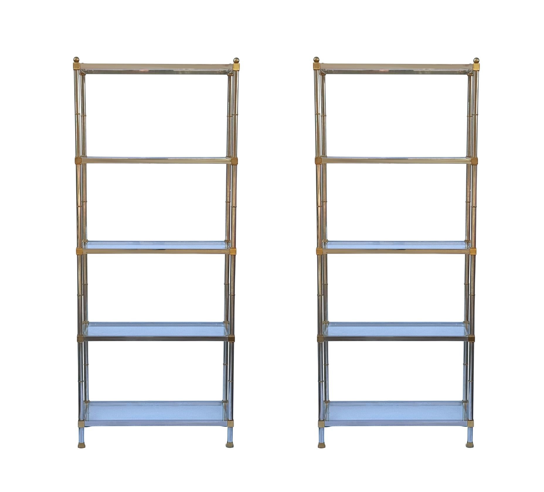 A beautiful pair of tall and very well made etageres from Italy circa 1970's. They feature chrome framing with brass accents and clear glass inlayed shelves. 