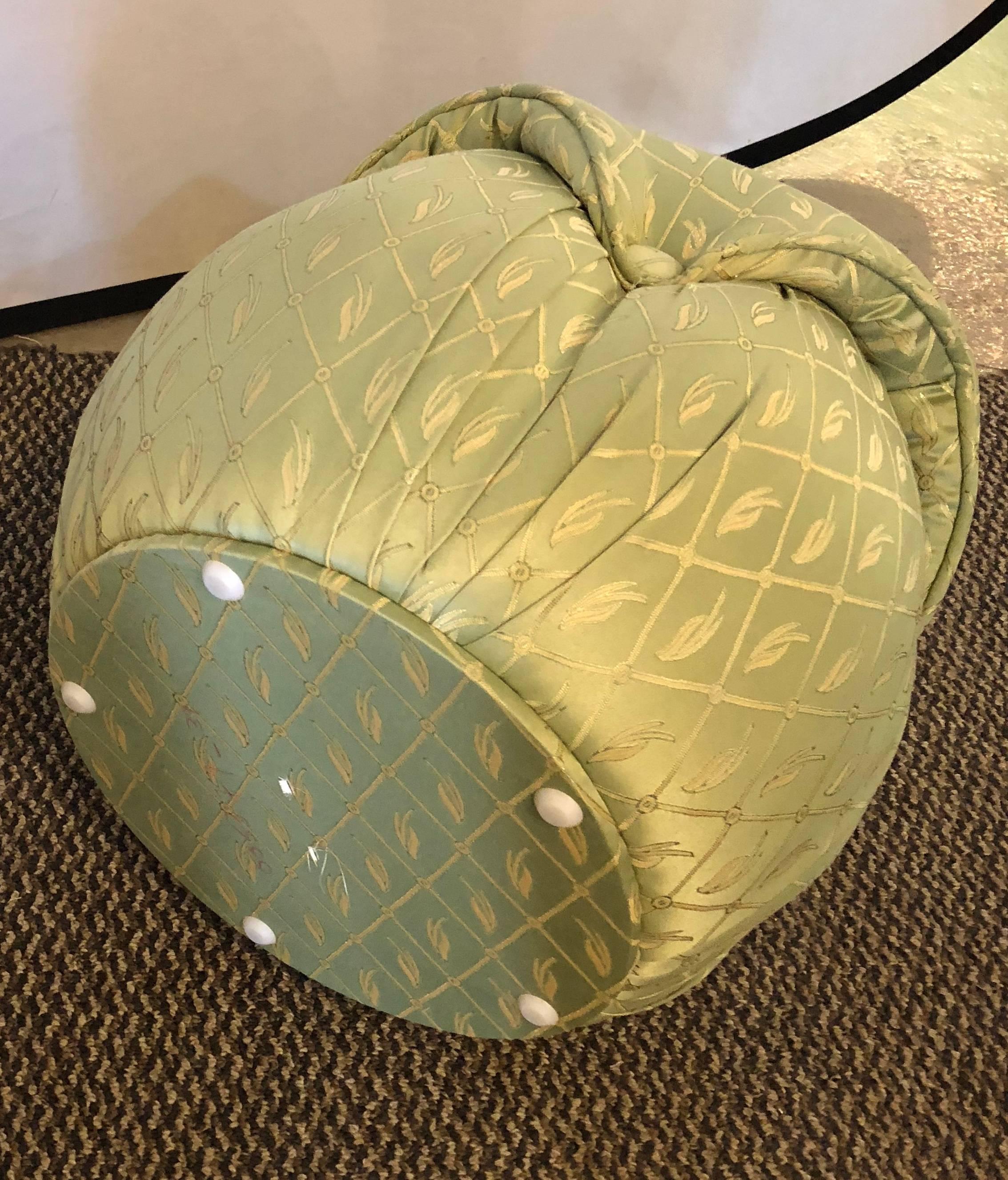 Pair of Hollywood Regency style finely upholstered mint green footstools / ottomans. A finely constructed pair of poofs that are wonderfully desirable.