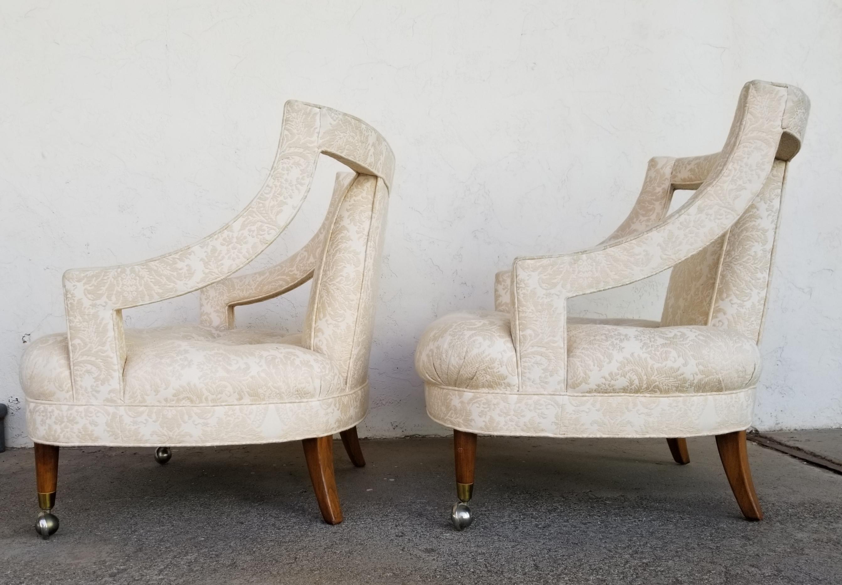 Pair of open arm upholstered lounge chairs in excellent original condition. Fine craftsmanship including solid walnut legs. Very comfortable oversized seats measuring 24