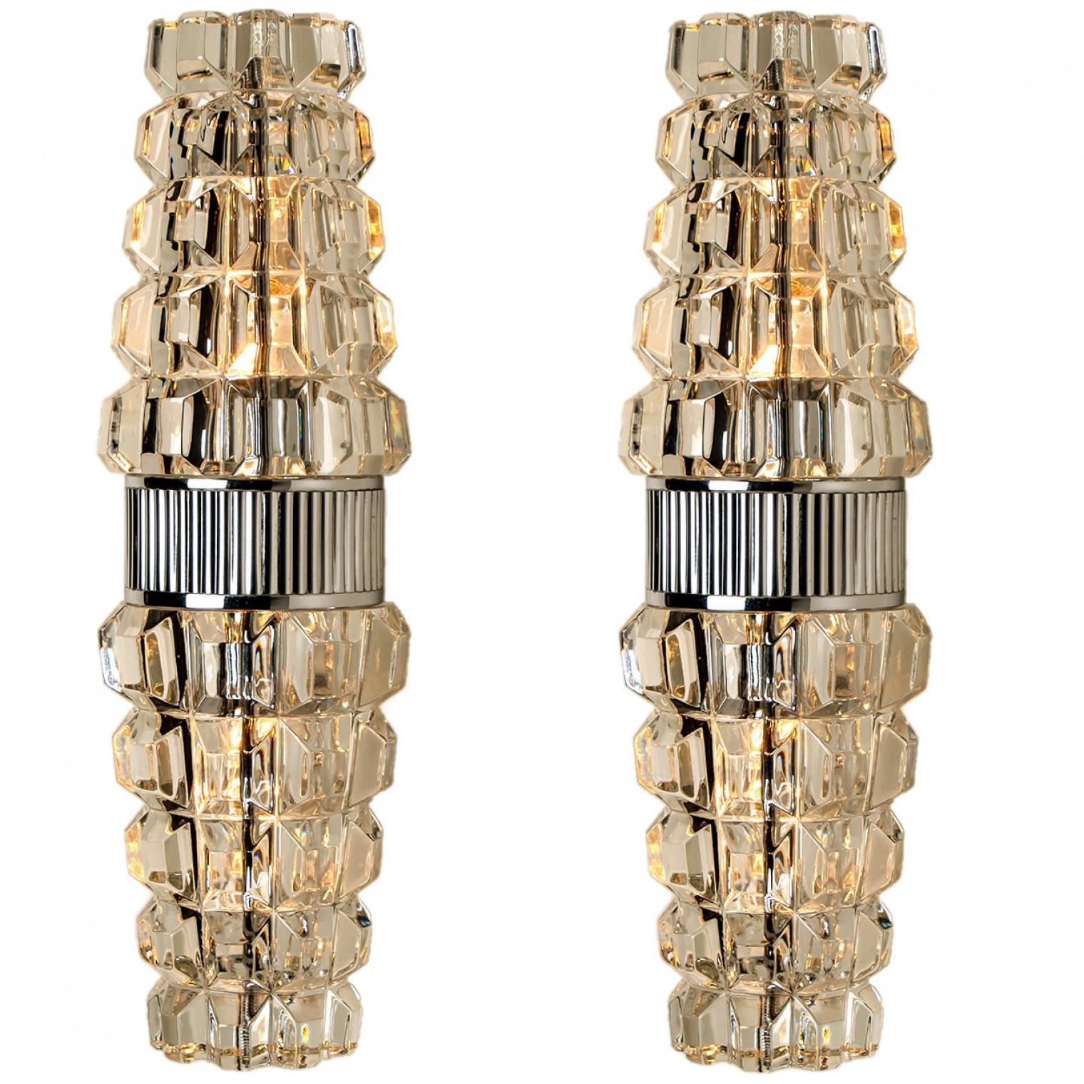 High-end wall sconces, made in France, Europe, around 1970. The wall lights are made of lead crystall and a chrome frame holding the glass.

Dimensions:
Height: 13.78 inch (35 cm)
Width: 3.94 inch (10 cm)
Depth: 5.9 inch (15 cm)

Please notice the