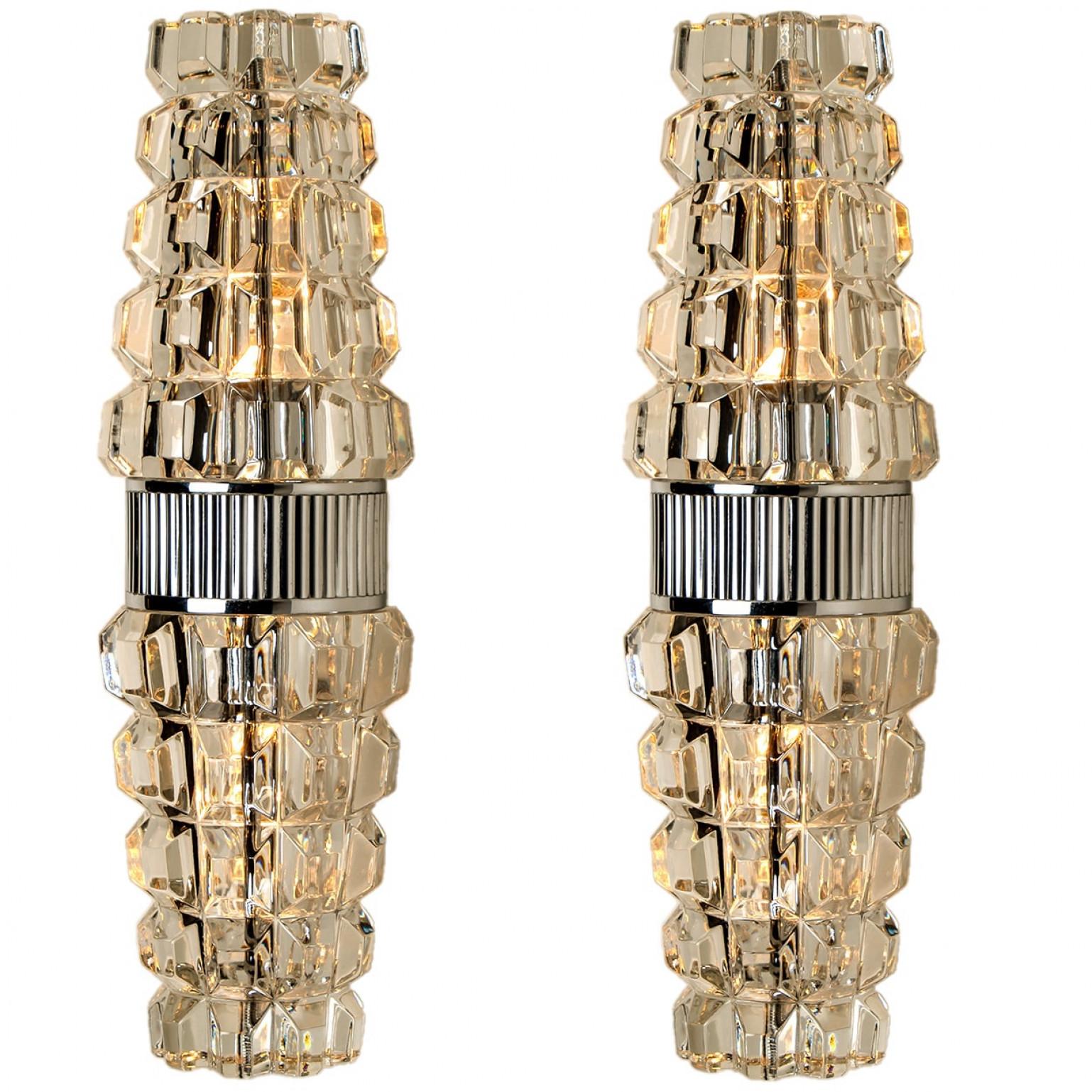 High-end wall sconces, made in France, Europe, around 1970. The wall lights are made of lead crystall and a chrome frame holding the glass.

Dimensions:
Height: 13.78 inch (35 cm)
Width: 3.94 inch (10 cm)
Depth: 5.9 inch (15 cm)

Please notice the