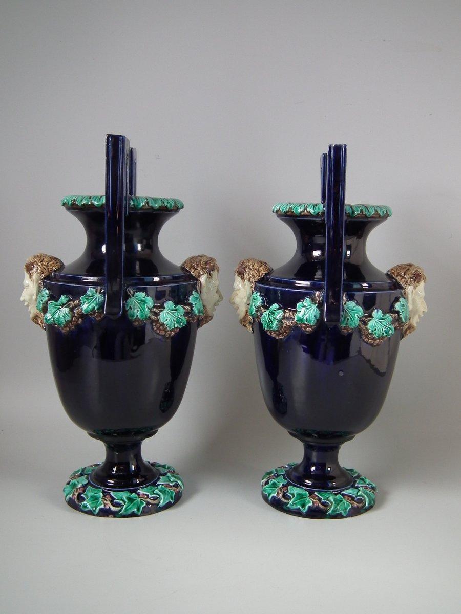 Pair of Hugo Lonitz Majolica vases which feature satyr masks to the side, with grape vine swags. Colouration: cobalt blue, green, cream, are predominant. The piece bears maker's marks for the Lonitz pottery. Bears a pattern number, '1430 6'.