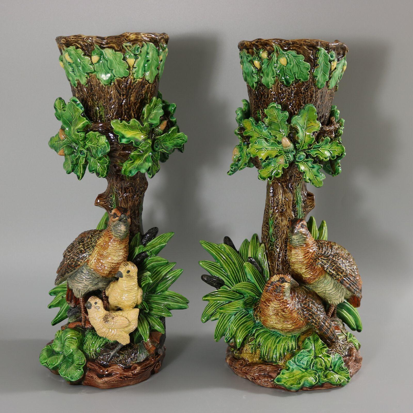 Pair of Hugo Lonitz Majolica original cache pots with stands which feature partridges in front of an oak tree, with reeds and bulrushes (cattails) either side. One partridge is looking after her young chicks. Removable, original pots. Colouration:
