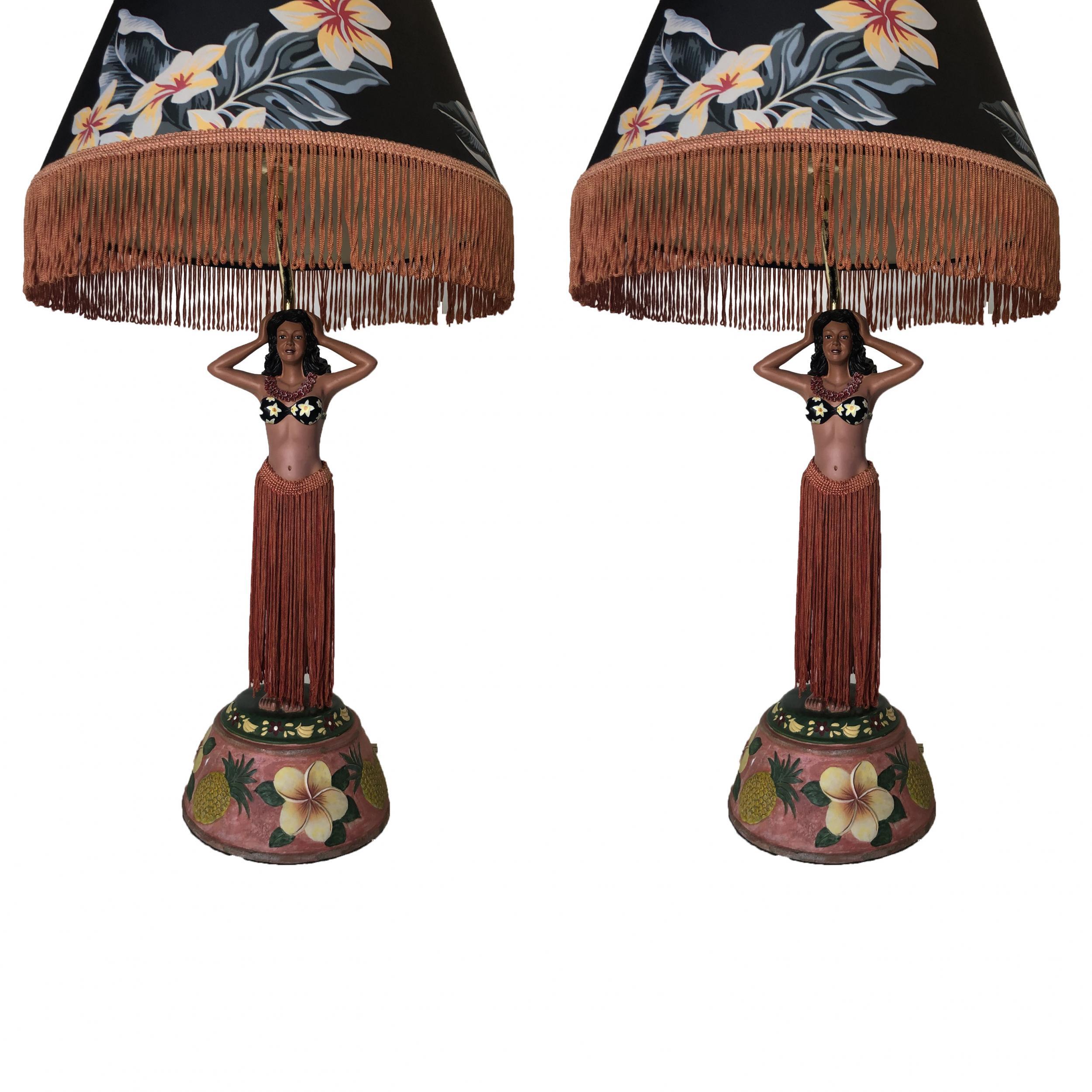 Pair of hula girl resin table lamp with floral fringe lamp shades.

Measures: 27