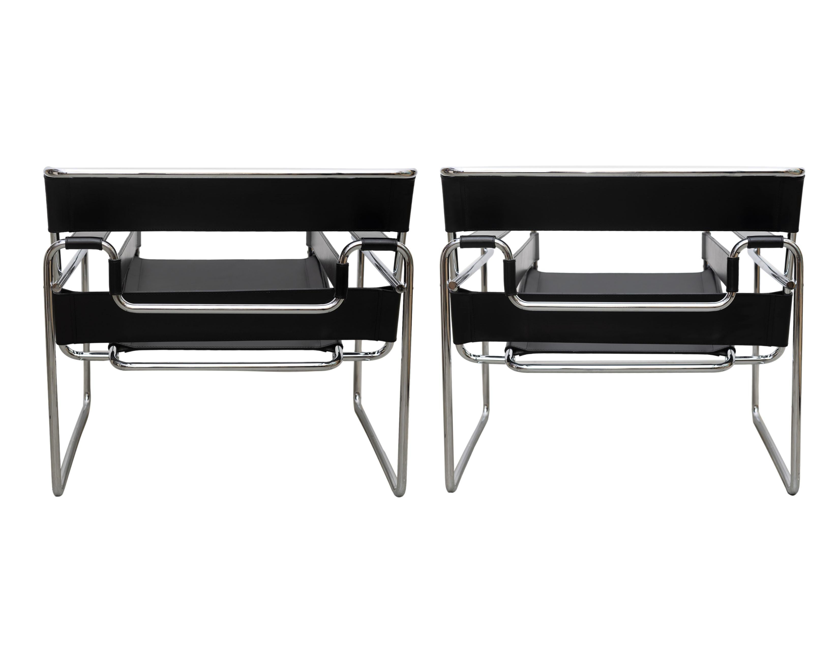 Pair of Iconic Wassily Chairs (Model B3) designed by Marcel Breuer (Hungarian-American 1902-1981).
Tubular chromed steel and black Italian leather, with 'Knoll Made in Italy' labels, and impressed cursive signature 'Marcel Breuer,' ca. 1974.