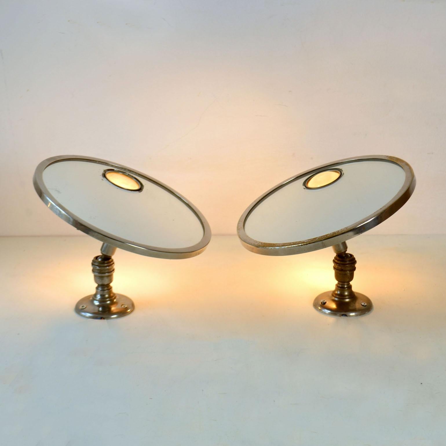 A pair of Brot Mirophar adjustable wall vanity mirrors with nickel plated frame and illuminated glass was created from 1927. The innovation of the Brot was the concept of an illuminated magnifying mirror with a fish-eye opaline glass. They were