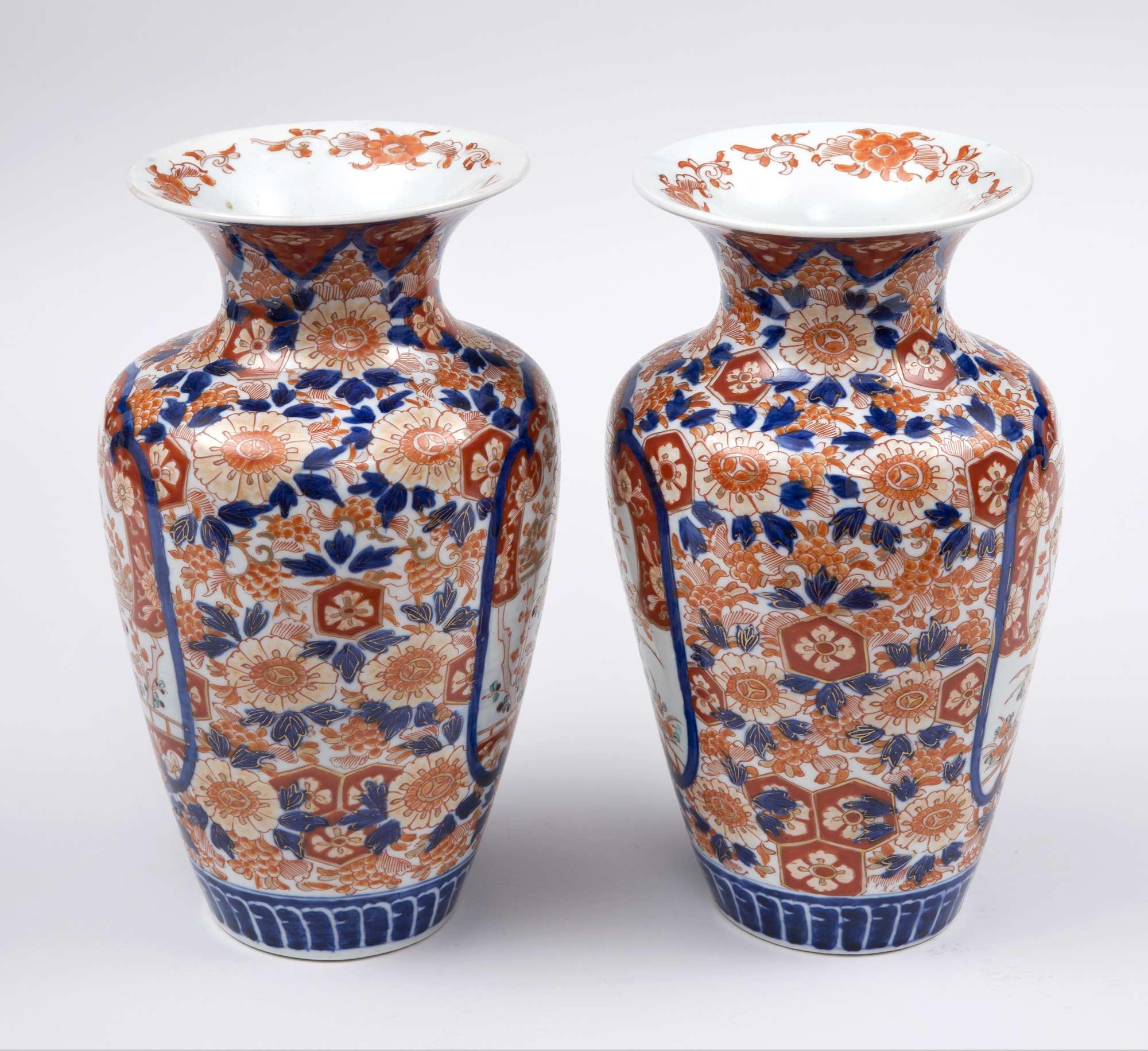 Pair of Imari open flared-neck vases decorated with two shield-shape panels within which are pairs of birds in a tree with flowers and butterflies, the sides with a floral decoration.