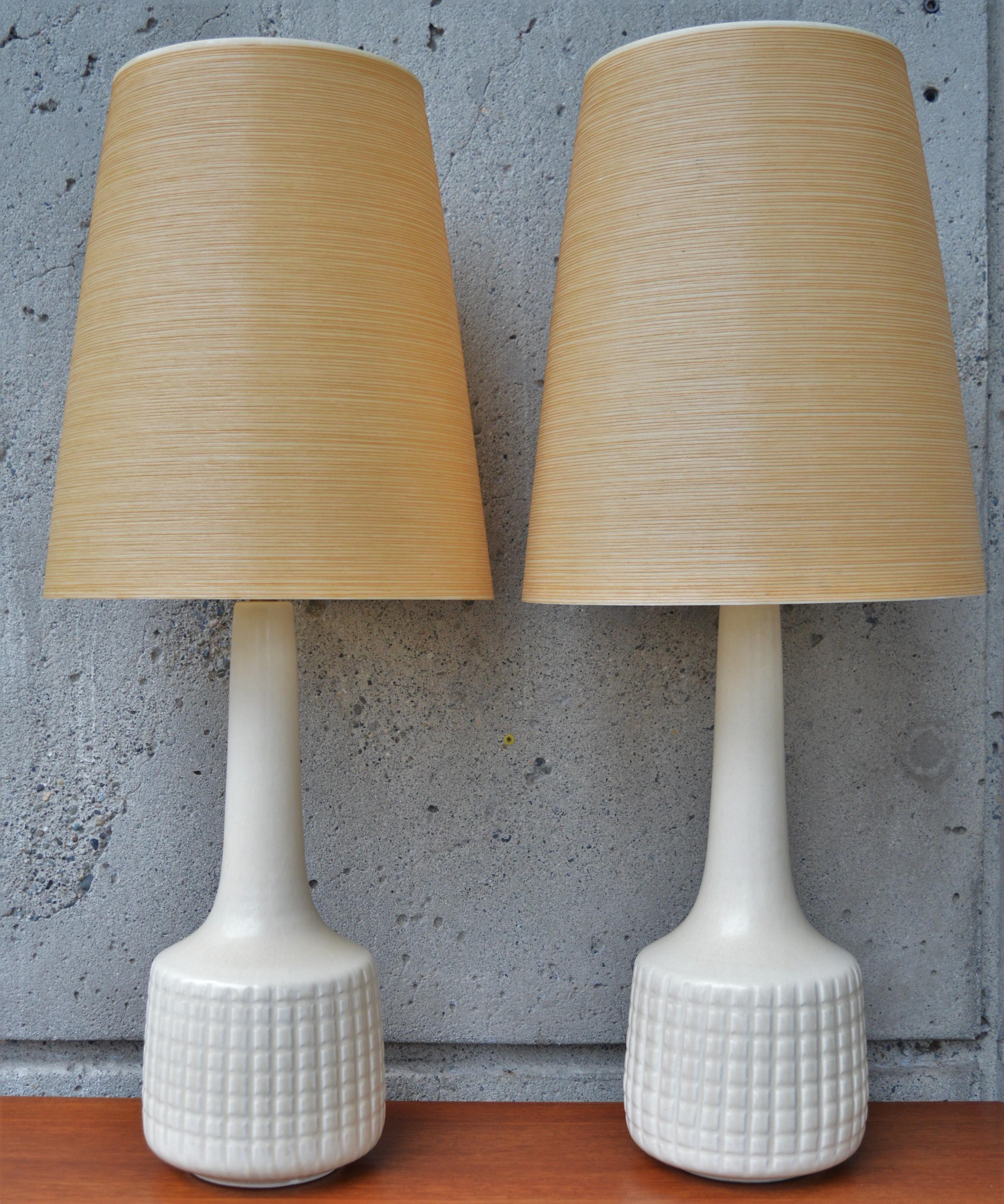 These sculptural ceramic lamps were designed and created by Lotte and Gunnar Bostlund, a Danish born couple who moved their lamp making company to Canada in the 1960s. The lamps are in a gorgeous off white and flare at the base and then taper gently