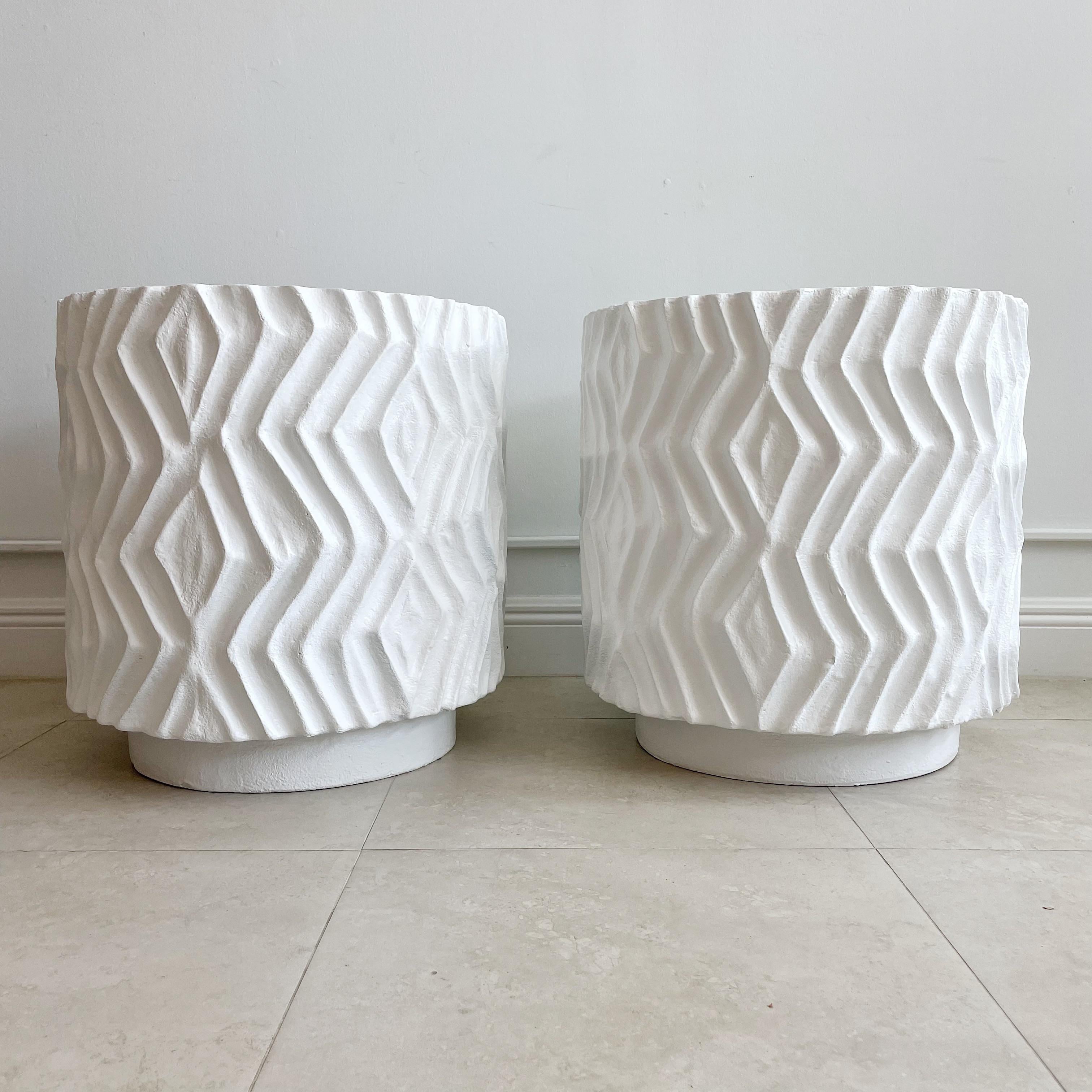 Pair large deeply incised solid plaster pedestals, end tables, side tables. These have been completely professionally restored. Unsigned circa 1980's. From a Palm Beach Estate. These tables are thick plaster and therefore extremely heavy.
