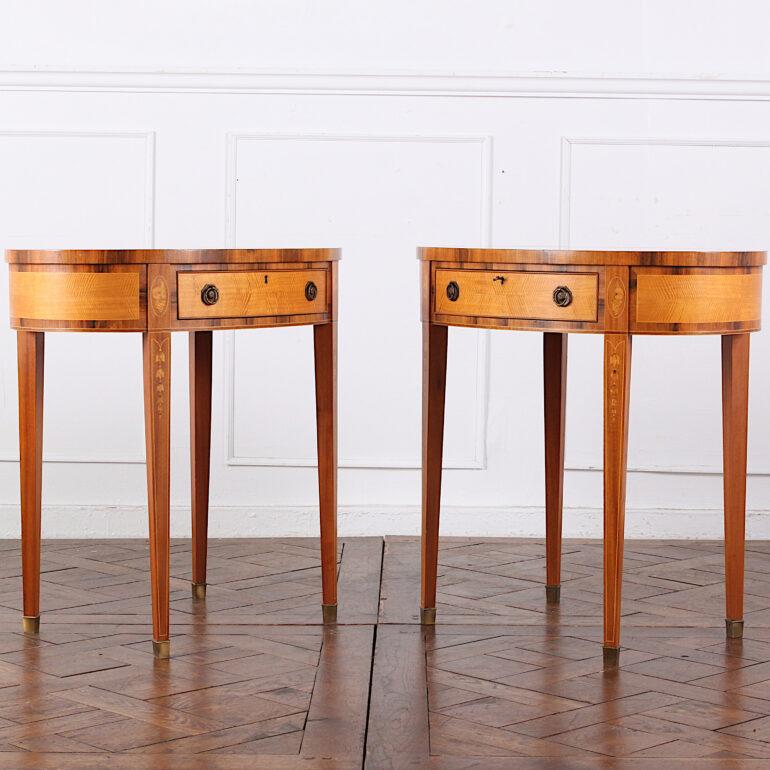 A superb quality pair of oval Sheraton revival side tables in mahogany and birch, inlaid with boxwood and banded in fruitwood. Oval marble tops above inlaid frieze, each fitted with a single drawer and standing on square-tapering legs with