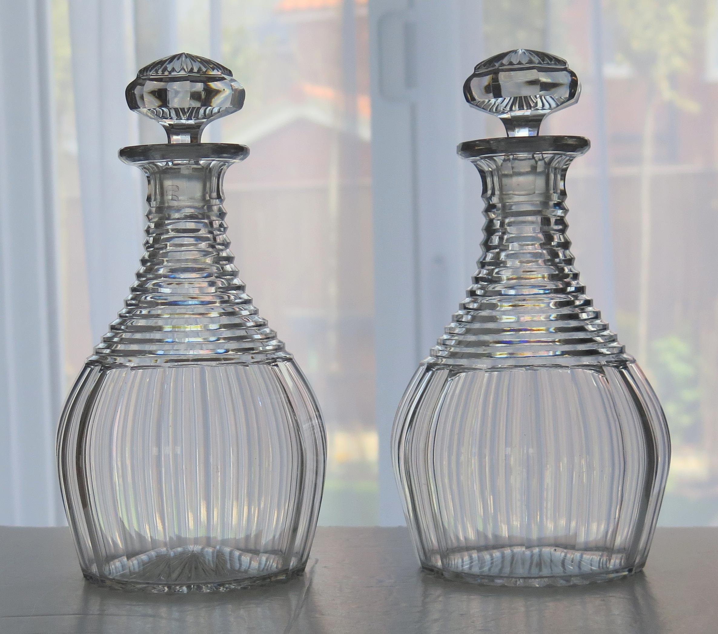 This is a fine and beautiful matching Georgian period PAIR of Irish cut-glass or crystal decanters, dating to the Regency period, Circa 1815.

Both decanters have a 