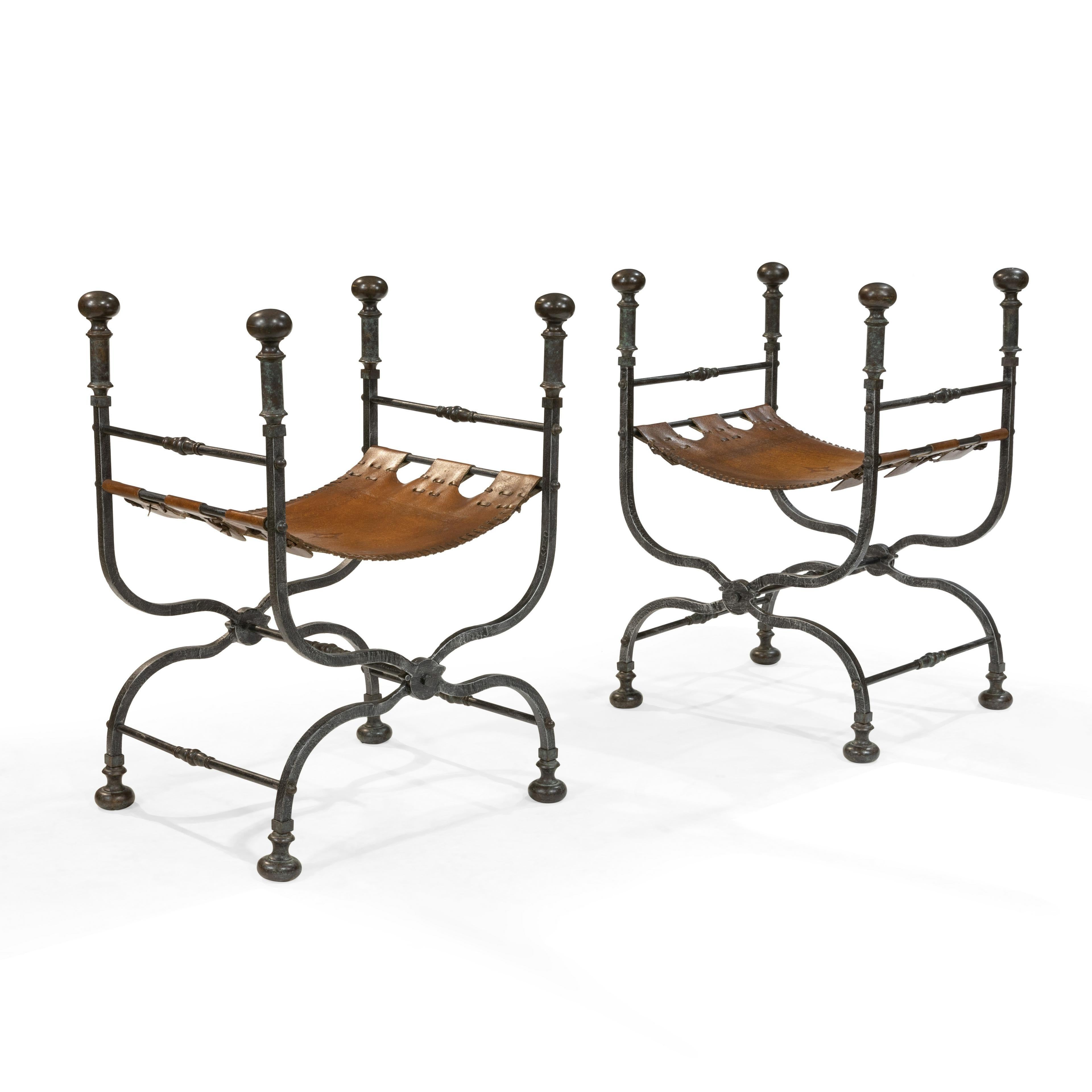 Pair of iron and leather Savonarola chairs / benches folding. A fine antique pair of Savonarola chairs in their original weaved seats. The strong sturdy metal frames fold and are certain to support any sitting weight.
Ehh.