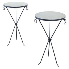 A Pair of iron and parchment drinks tables with ring decoration.