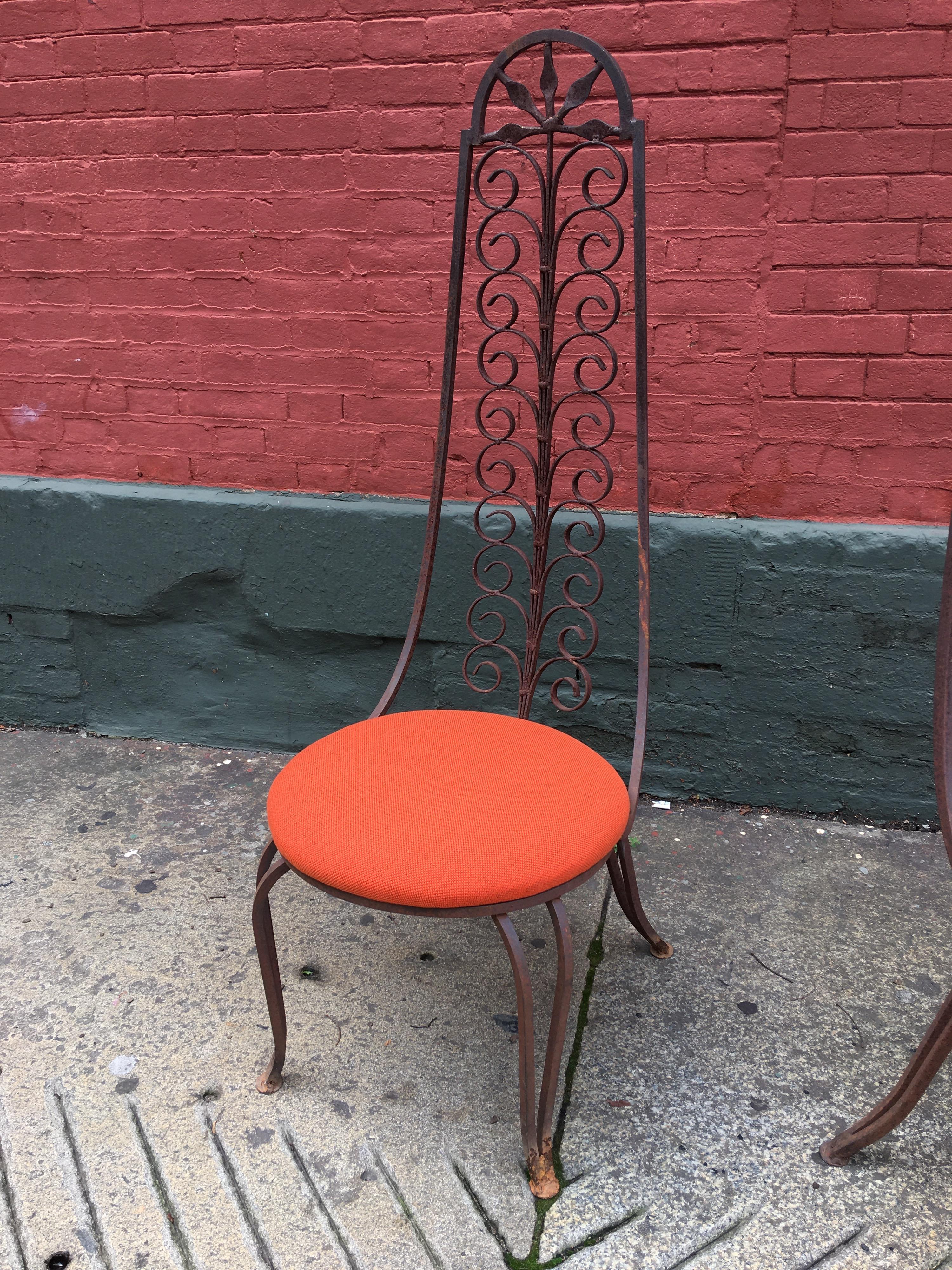 Dramatic high back iron chairs with a round newly upholstered seat cushion. Frames are in an as found condition. The untreated iron has a great look and show a nice amount of patina! Easy enough to powder coat or paint any color you might like!