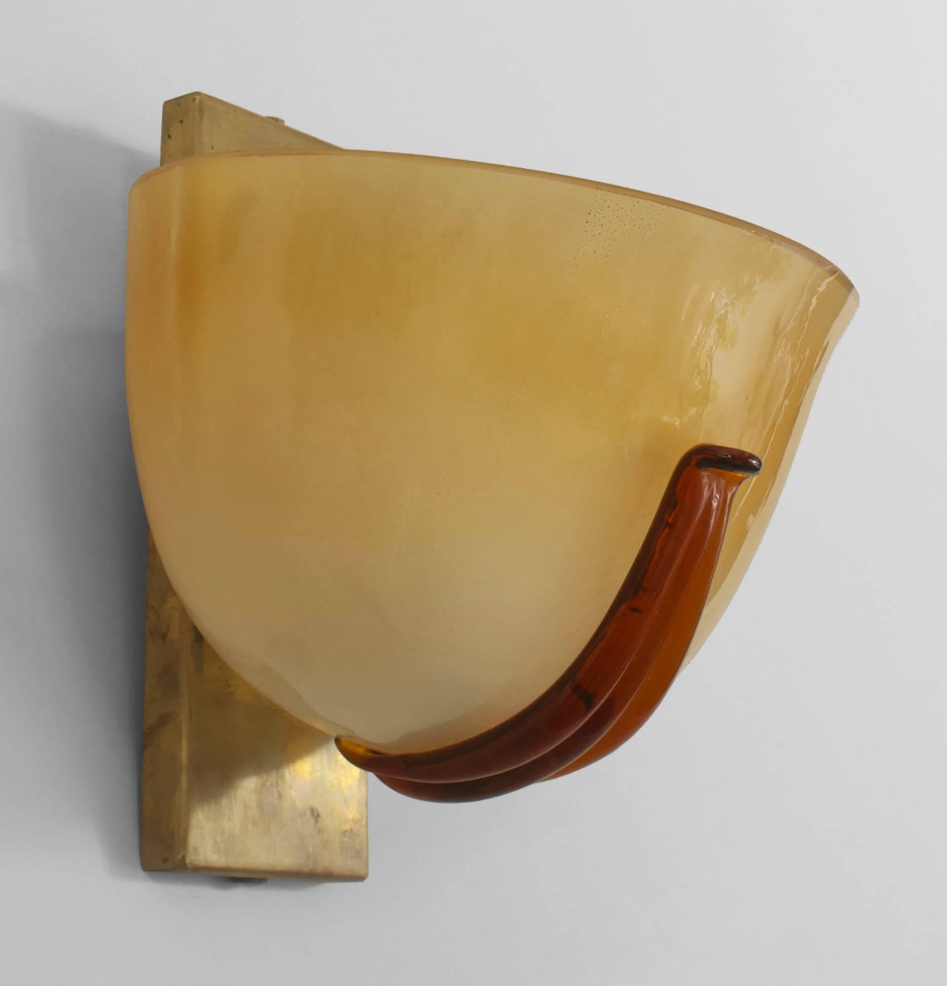 Pair of Italian 1940s Venetian Murano gold dusted glass wall sconces in the form of a half-round bowl secured by a brass backplate and having a dark amber applied glass strip in front.

 