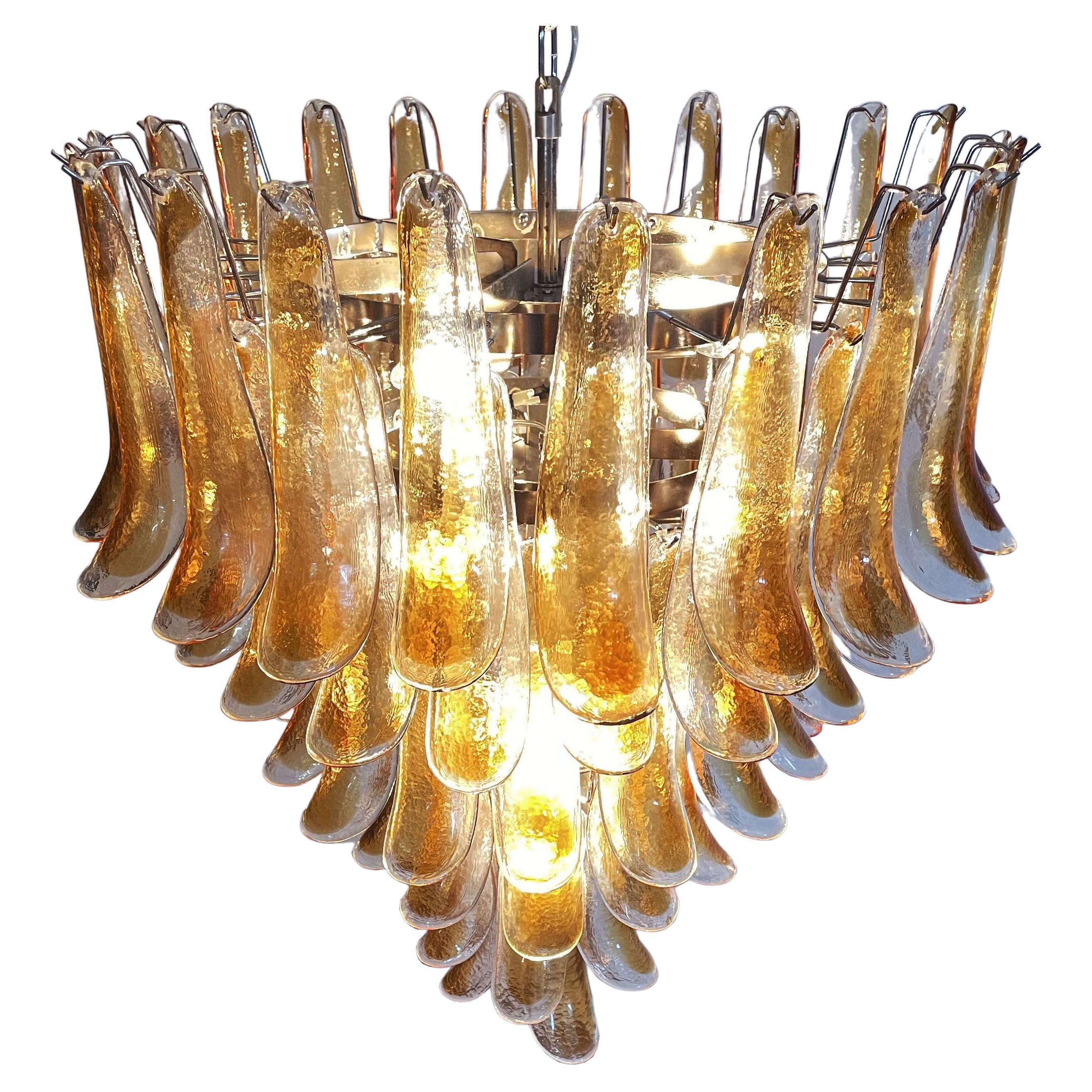 Pair  Italian vintage Murano chandeliers made by 75 glass petals transparent with an amber spot inside, nickel metal structure. The glasses are very high quality, the photos do not do the beauty, luster of these glasses.
Period:late XX