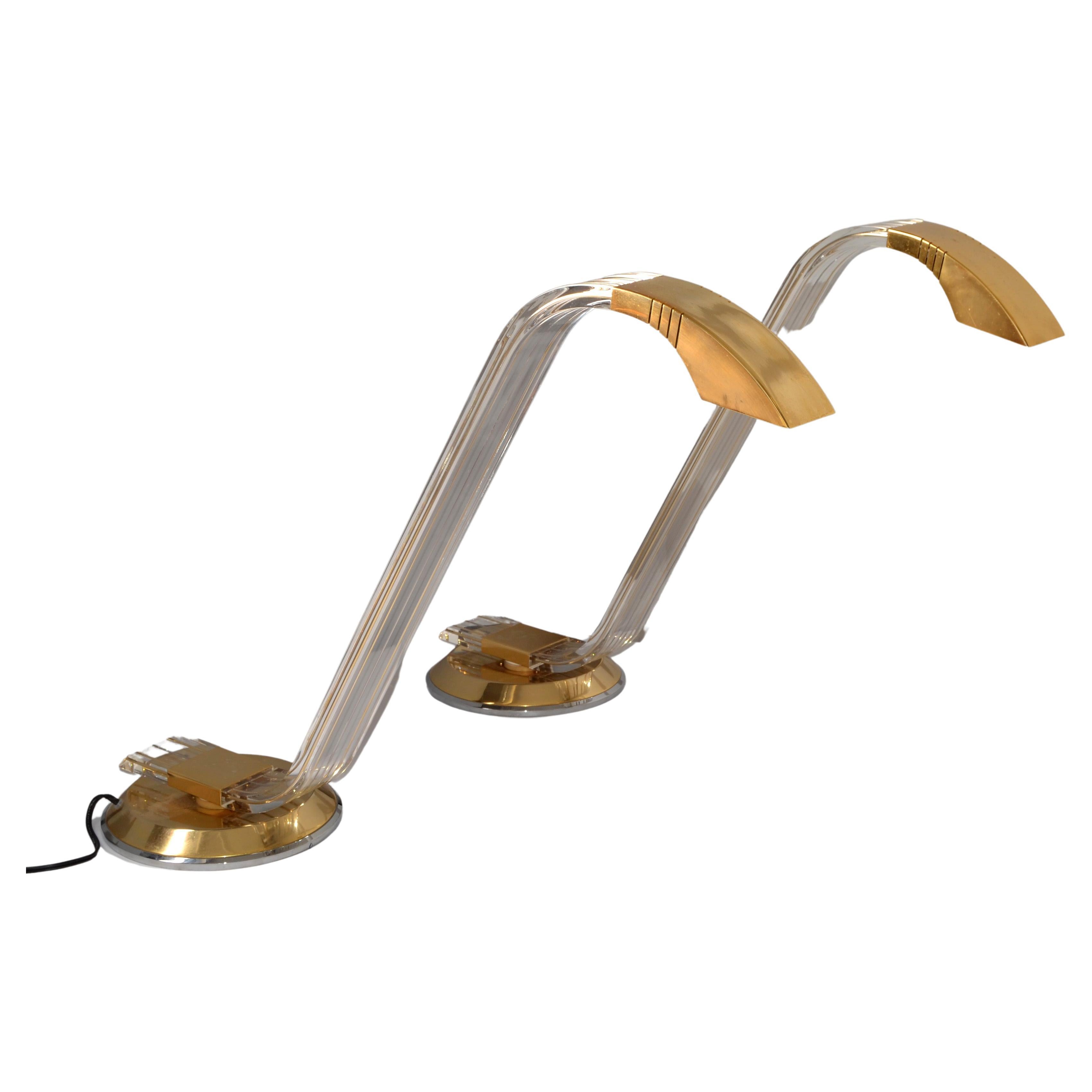 Pair of Italian Arredoluce attributed Mid-Century Modern Swing Brass Lucite Table or Desk Lamps made in the 1970s.
Features a Gooseneck Style Lucite Stem filled with Brass Lines and swings 1/2-way around. The Round Base is Brass plated and the