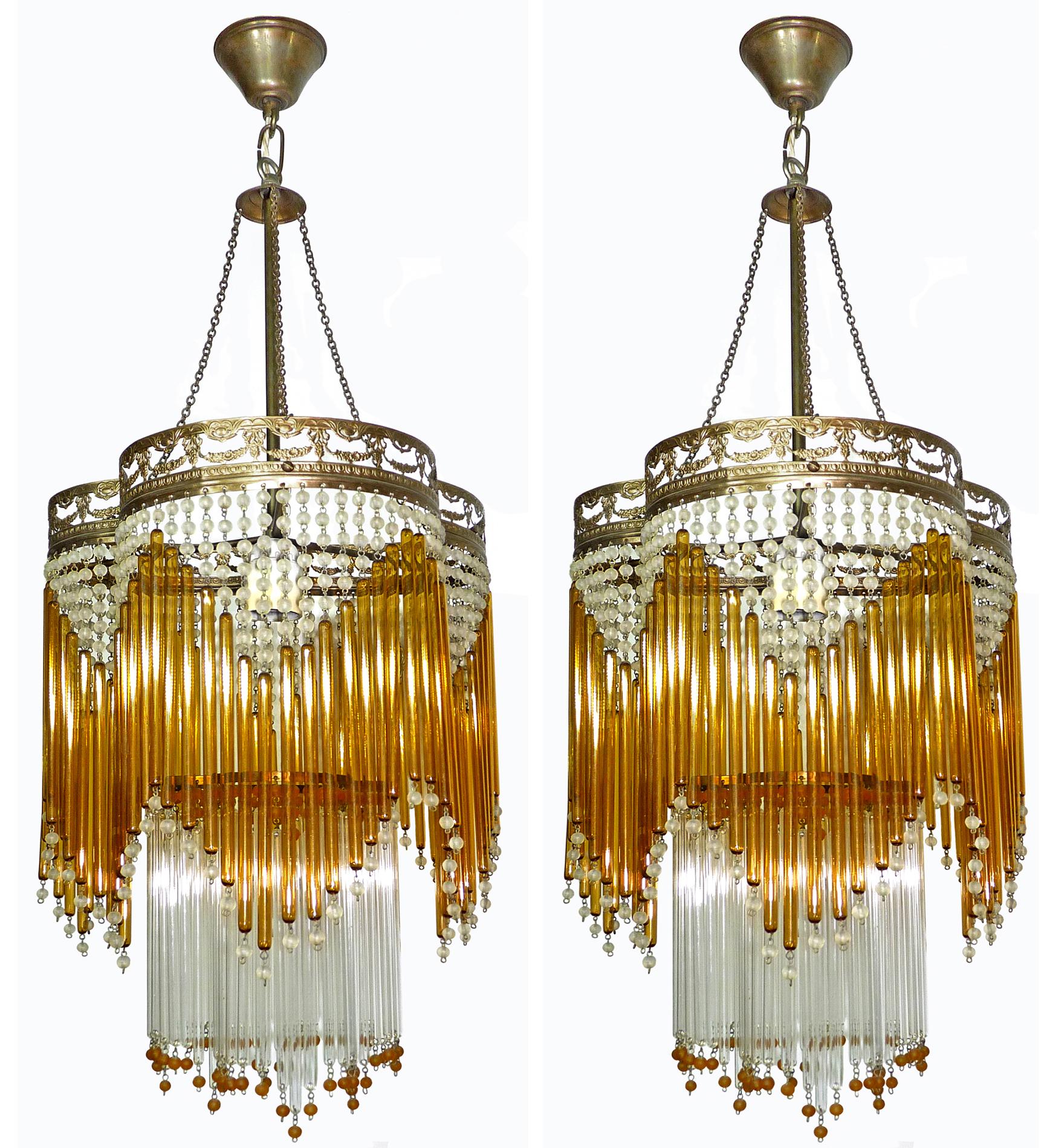 Beautiful pair of Italian midcentury in clear and amber Murano beaded glass Art Deco / Art Nouveau chandeliers.
Measures:
Diameter 30 cm
Height 87 cm
One light bulb each E27/ good working condition/European wiring.
Age patina.
 