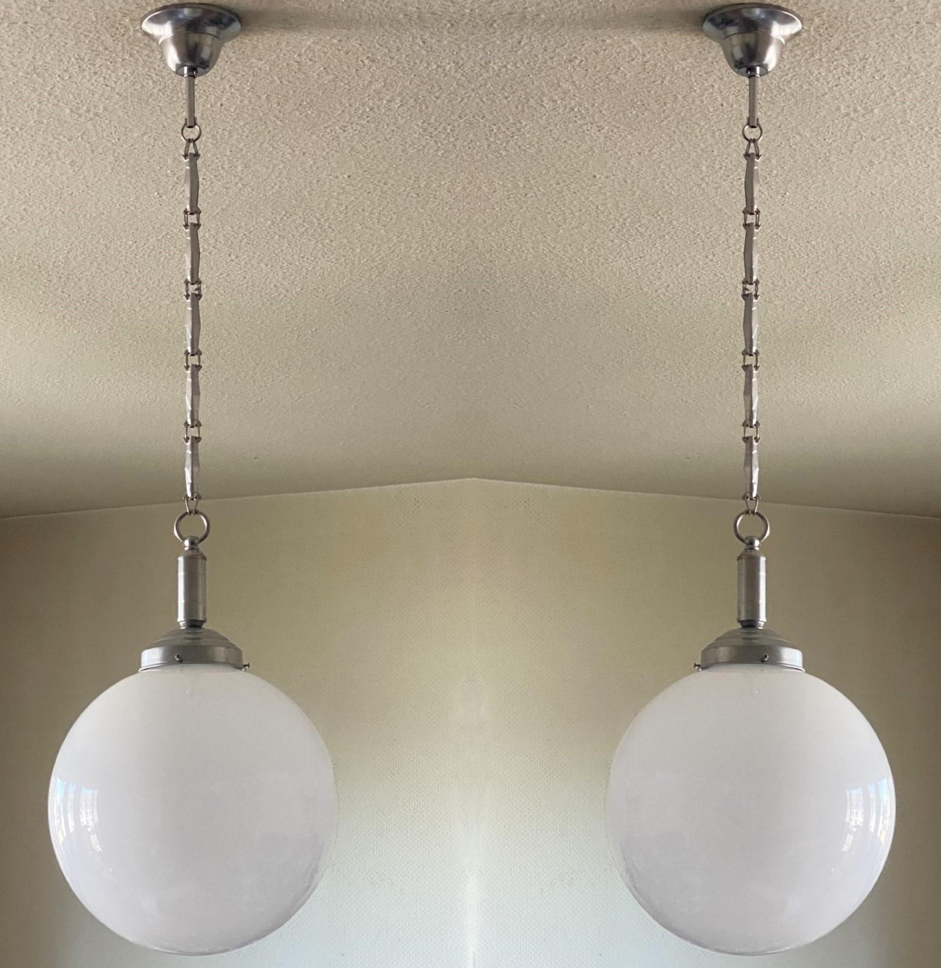 Pair of hand blown Opaline glass ball pendants with chrom finish brass mounts, Italy, 1940-1949.
One E27 light socket for a large sized bulb up to 100W. Led Bulbs can also be used.
Measures: Diameter 12