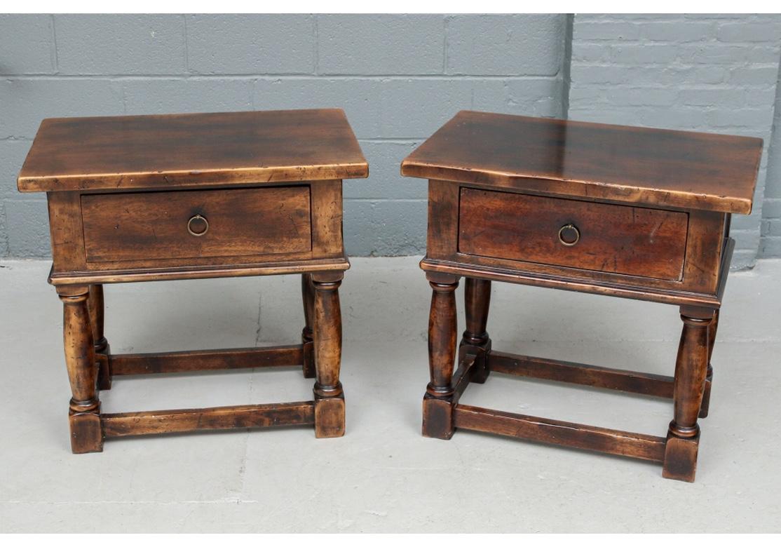 A Pair of very well made Rustic Style end tables in very good condition. Craftsman Guido Zichele. Maple with walnut veneer in an intentionally distressed mottled finish. 17th Century style end tables with a single apron drawer having Ring Pulls and