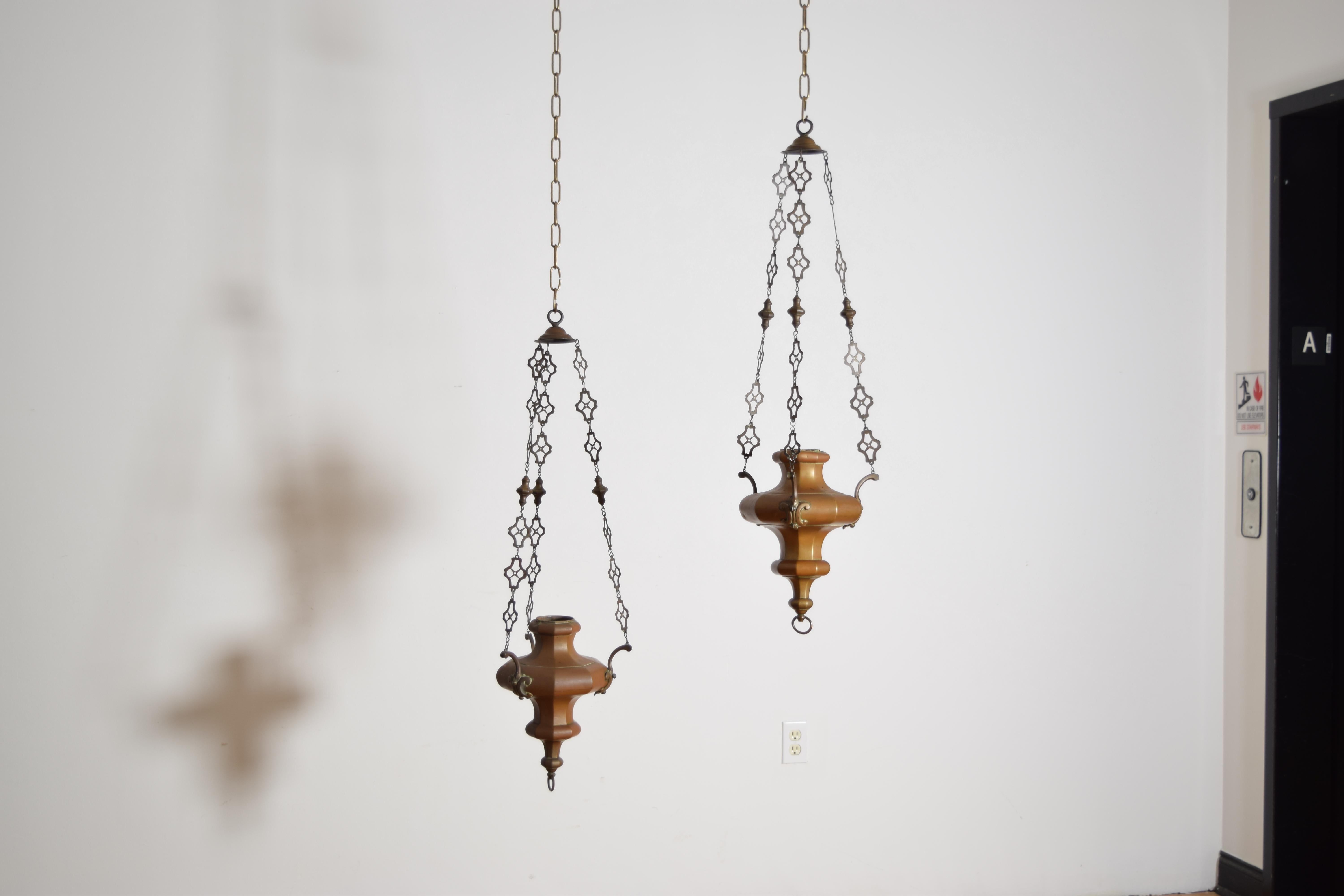 hanging from their original pierced brass chains these censers with urn shaped bodies each extending three arms with c-scroll decorations, censers were used in churches to burn incense during mass, these would have been raised and lowered on pulleys