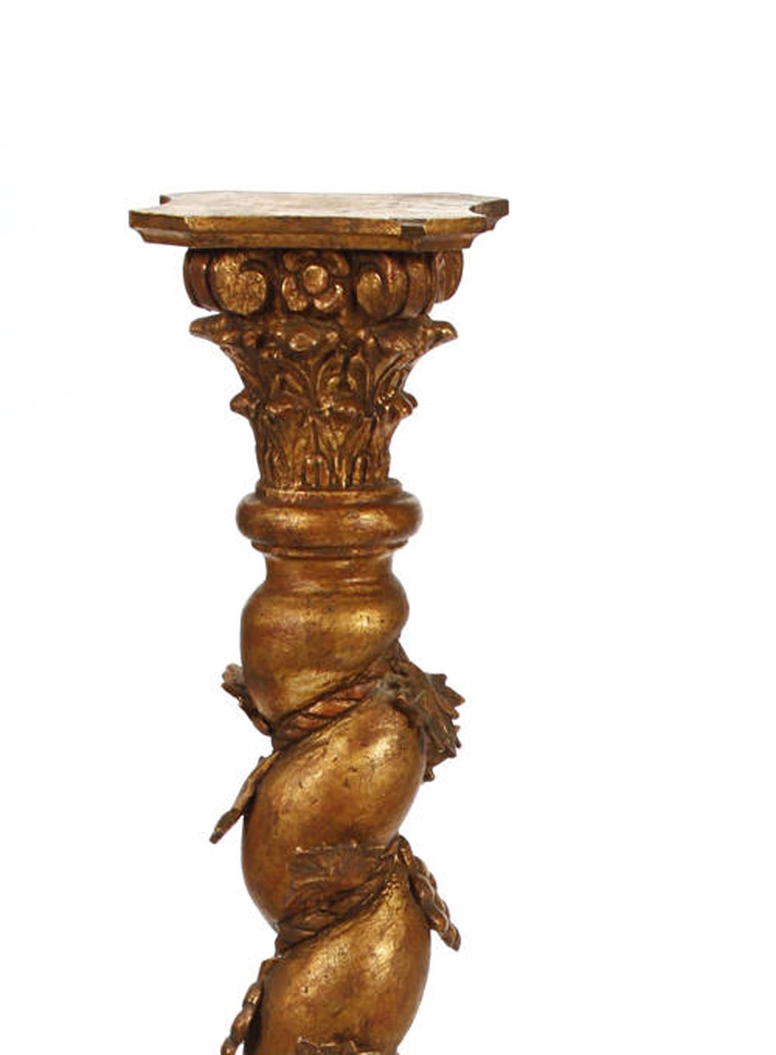 Beautiful pair of Italian Baroque style Solomonic giltwood column pedestals, late 19th century.

The carved giltwood Corinthian style columns are centered with spiral supports and decorated with a vine of foliate and fruiting motif.
