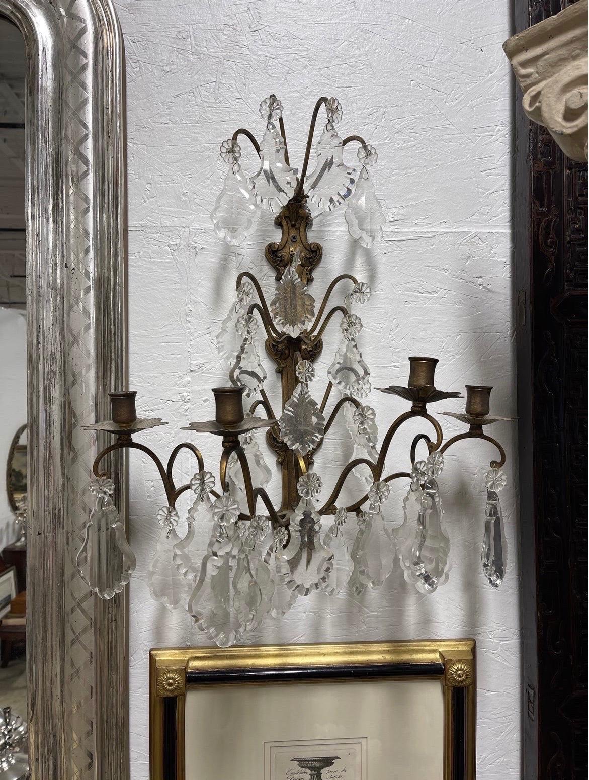 A pair of heavy bronze and crystal prism candle sconces. Each having 4 candle holders and wall mount to plate. 
Note: These can be French wired for a $100 fee.