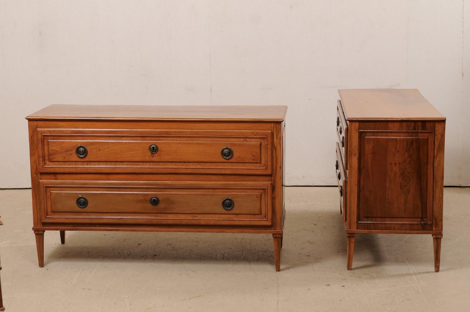 An Italian pair of nicely sized fruitwood chests from the turn of the 18th and 19th century. This pair of antique cassettiere (Italian for chests of drawers) from Italy each features a rectangular-shaped top, over a decoratively raised paneled case,