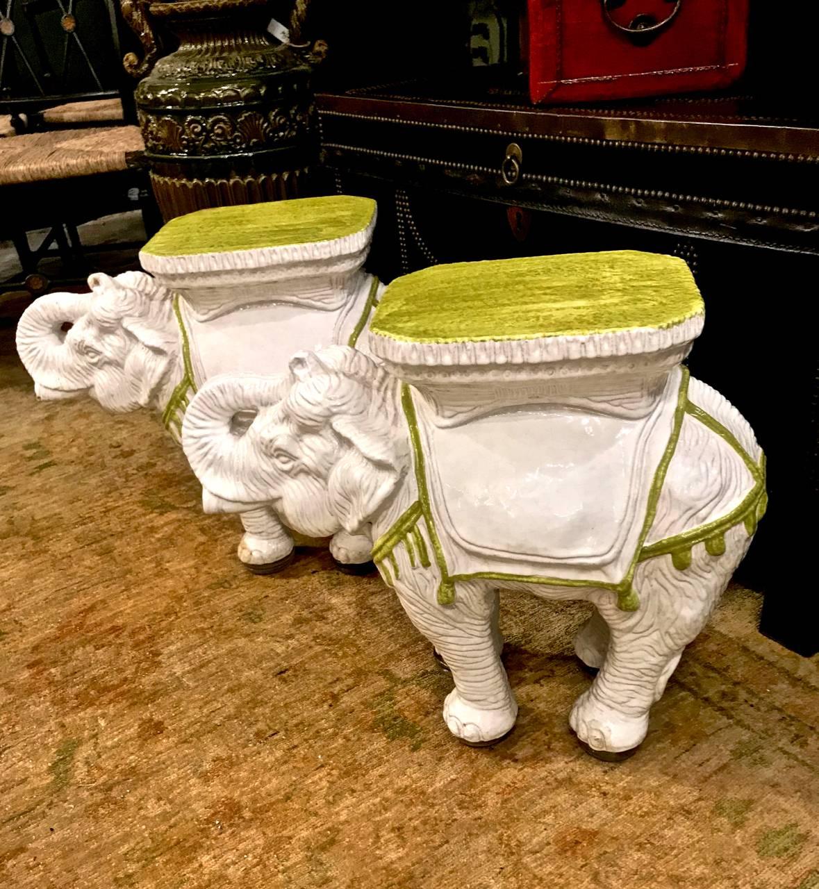 This is a great pair of c.1960s Italian ceramic garden stools or tables. These highly decorative white toned elephants are cast in fine detail and decorated with a lime green trimmed yellow seat. Both of the elephants are in overall excellent