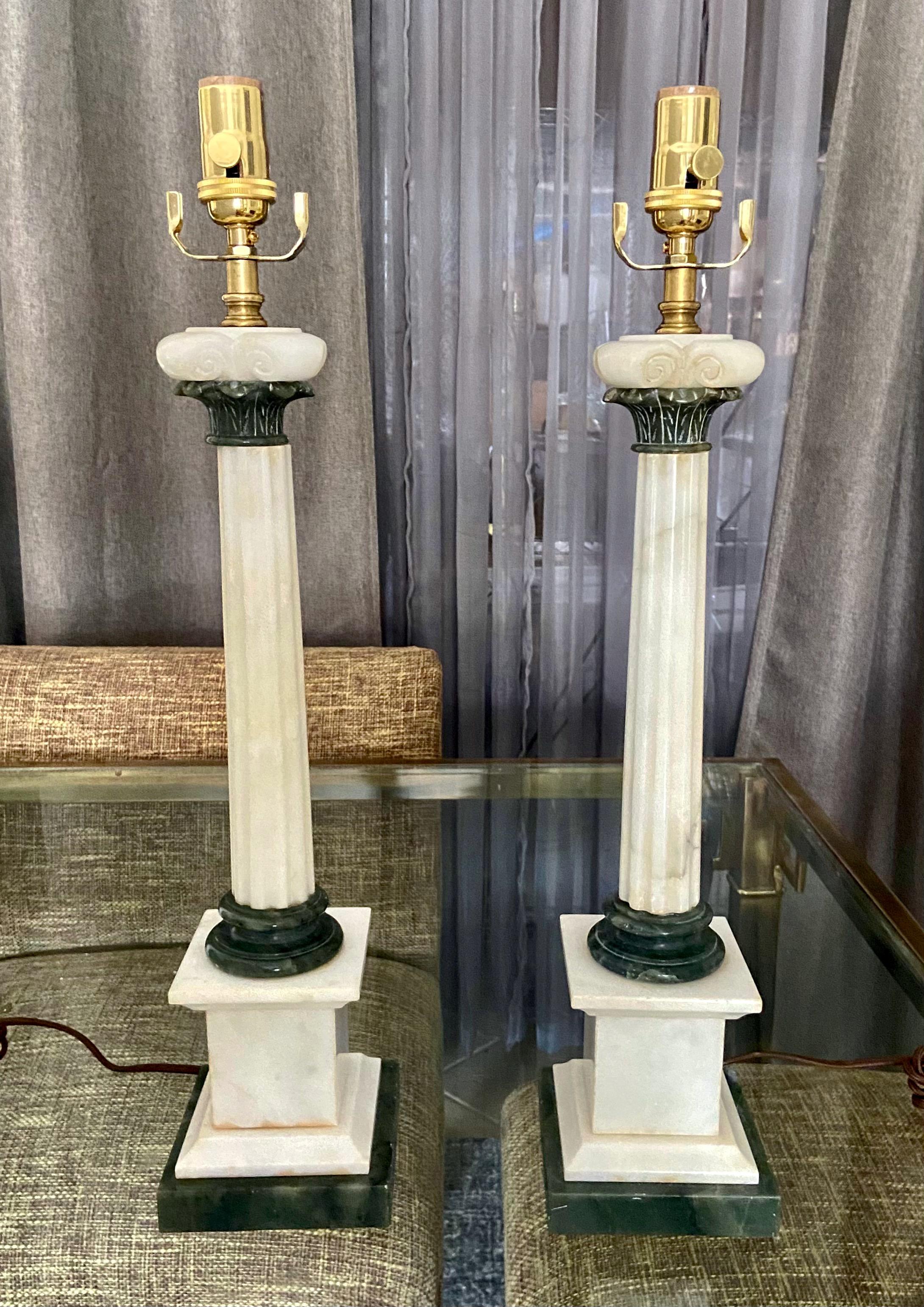 Pair of finely crafted hand carved neoclassical style column form alabaster lamps. Expertly crafted with combination white and green elements. Newly wired with new brass 3 way sockets and rayon cords. Shades are not included.
Measures: Height to