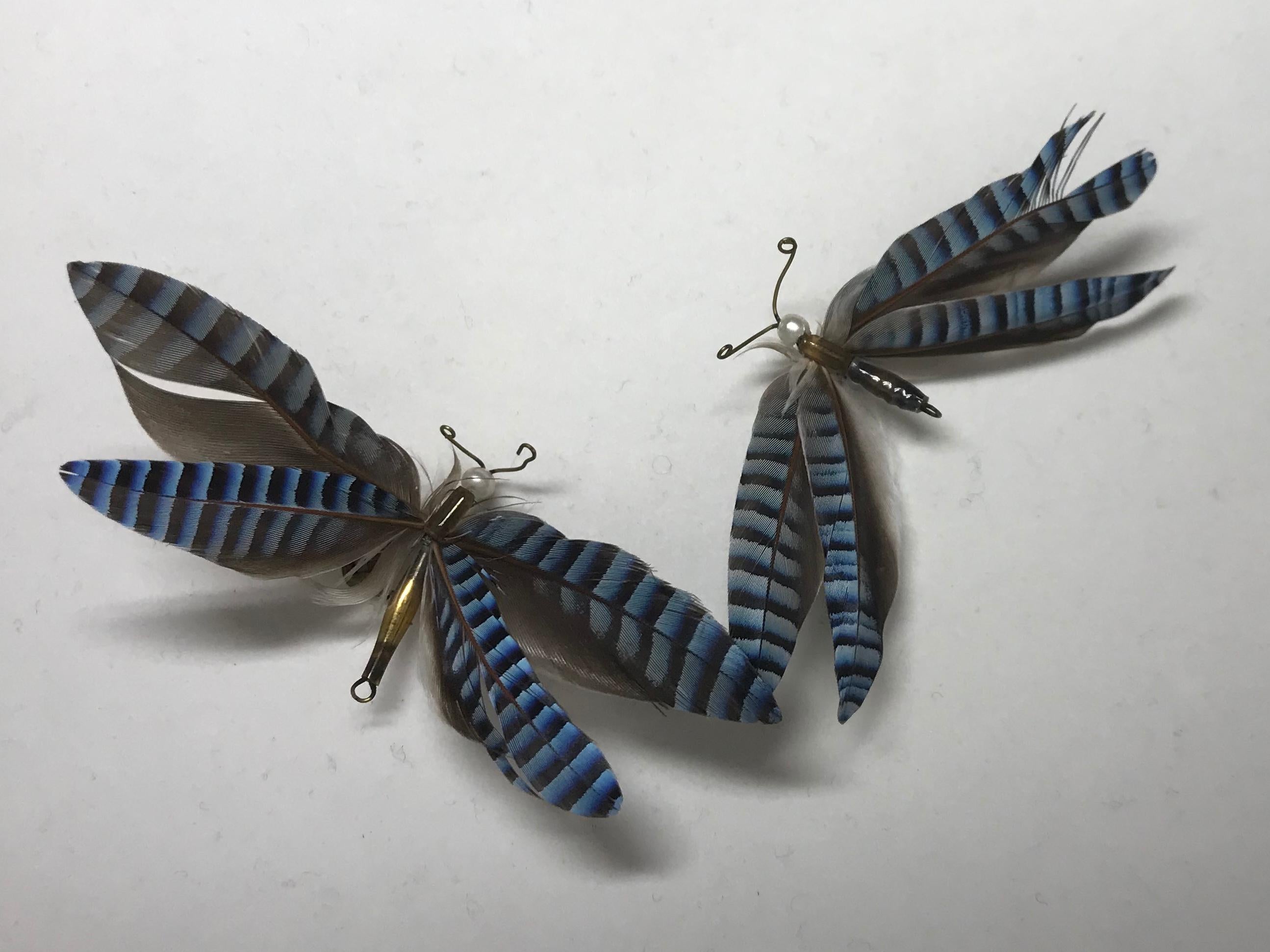 Pair blue feather butterfly brooches. Pair unusual butterfly brooches fashioned from the feathers of the European Jay. Italy, circa 1900.
Dimensions: 3” W x 1 1/2” L.
   