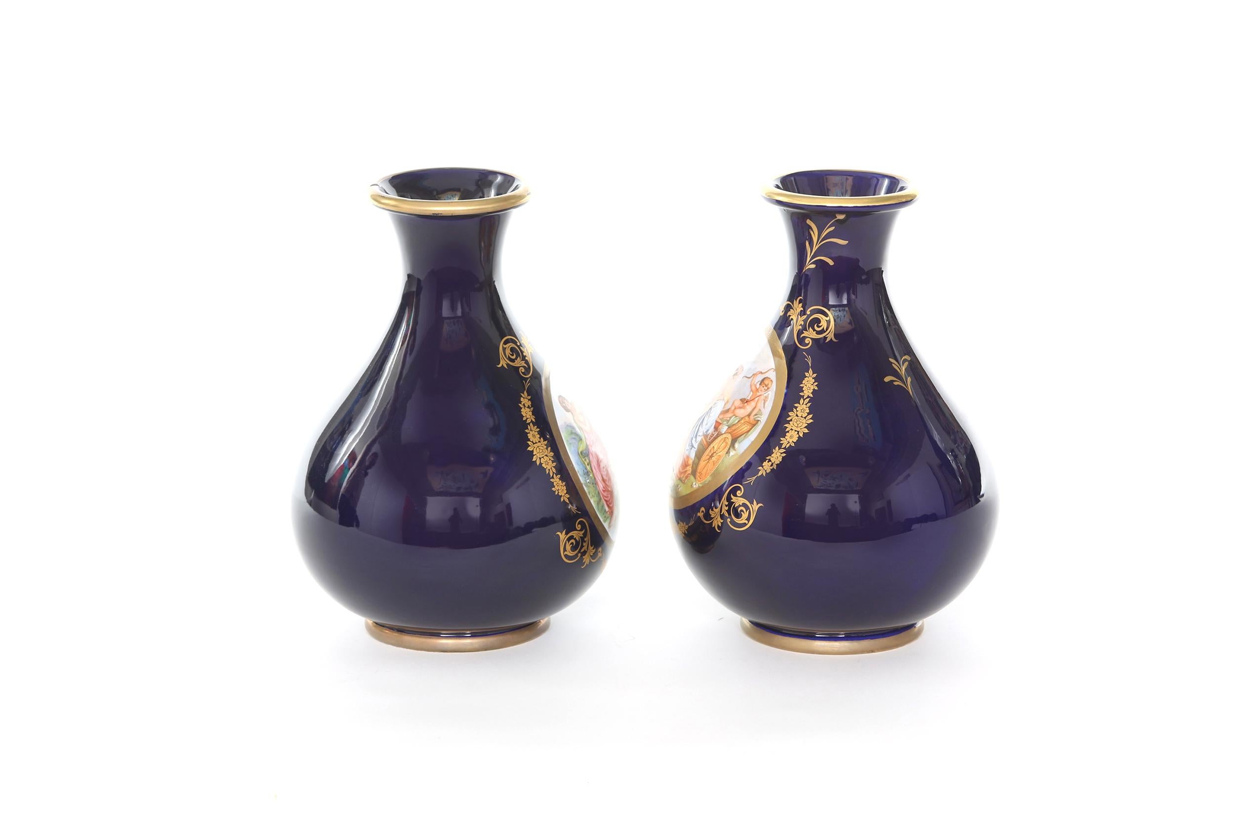 Mid-20th century Italian gilt porcelain decorative pair of vases with exterior design details. Each vase is in great condition. Minor wear consistent with age / use. Maker's mark undersigned. Each vase stands about 11 inches tall x 7.5 inches