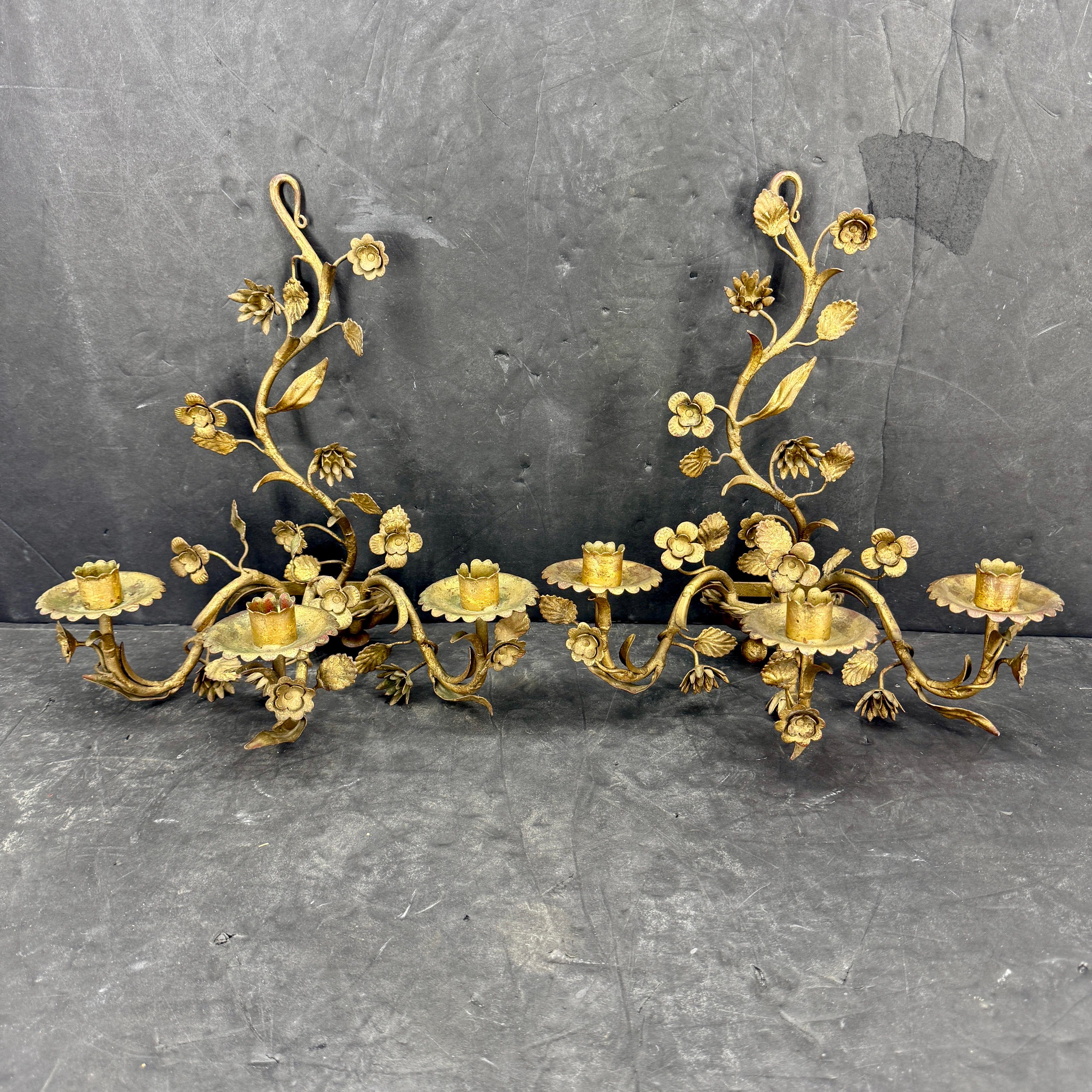 Gold Gilt Pair Tole Metal Wall Floral Candle Sconces, Italy. Elegant wall candle sconces with beautiful floral detail throughout. The hand-painted gold gilded finish on this pair have a very pleasing aged look. These classic pair of candle wall