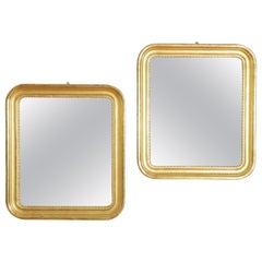 Pair Italian Late Neoclassic Carved Giltwood 
Gilt Gesso Mirrors, ca. 1835