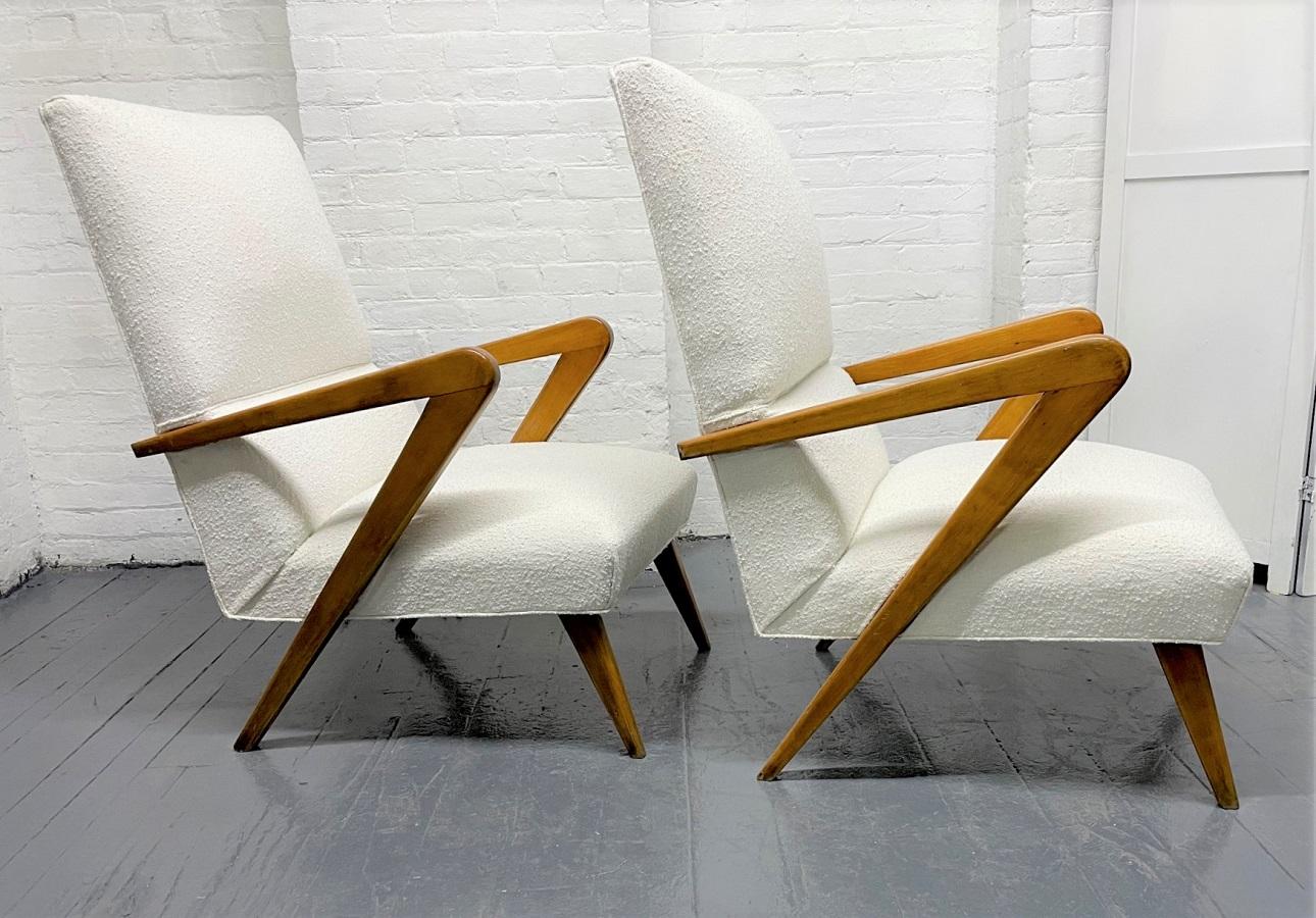 Pair Italian lounge chairs style of Gio Ponti. The chairs have Boucle upholstery with walnut frames.