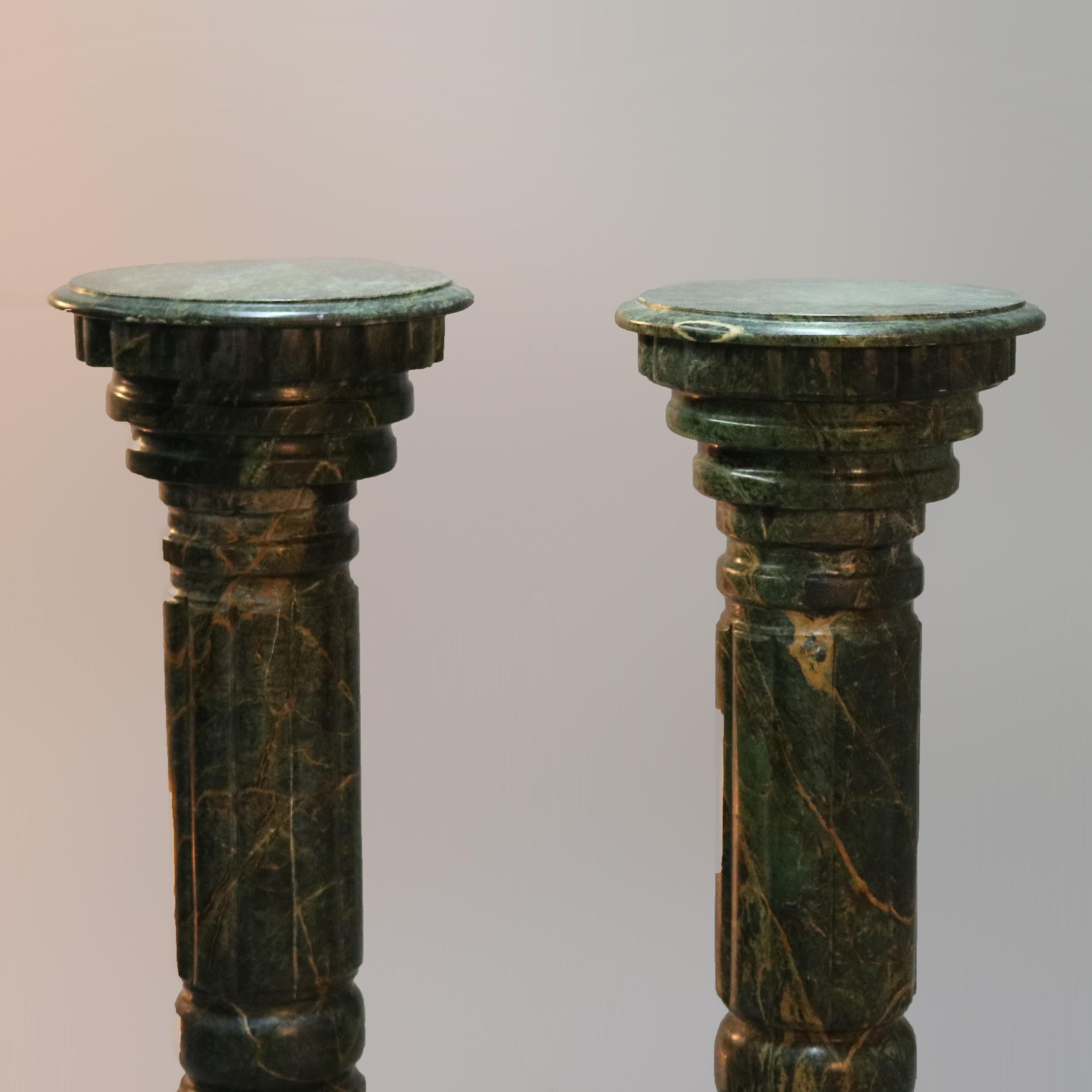 A matching pair of Italian deeply striated malachite green marble sculpture display pedestals offer classical Greek Doric form with circular display surmounting carved pedestal seated on stepped bases, 20th century

Measures: 41.75