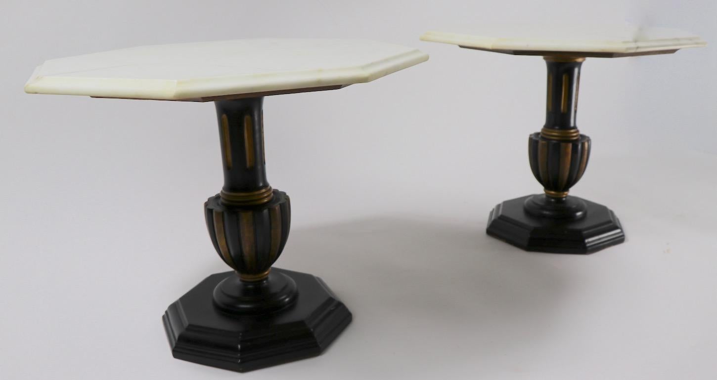 Stylish pair of side or end tables each having an octagonal marble top, supported by a polychrome (gold and black) wood base.
Both are ain good, original condition showing only minor cosmetic wear normal and consistent with age (1950s-1960s). Made